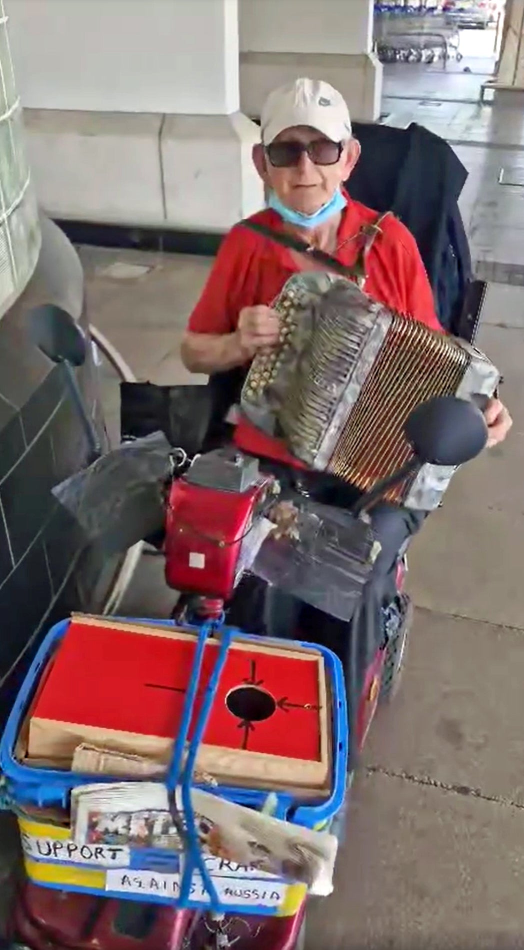 O’Halloran, 87, on his mobility scooter playing the accordion outside Tesco, Perival, west London