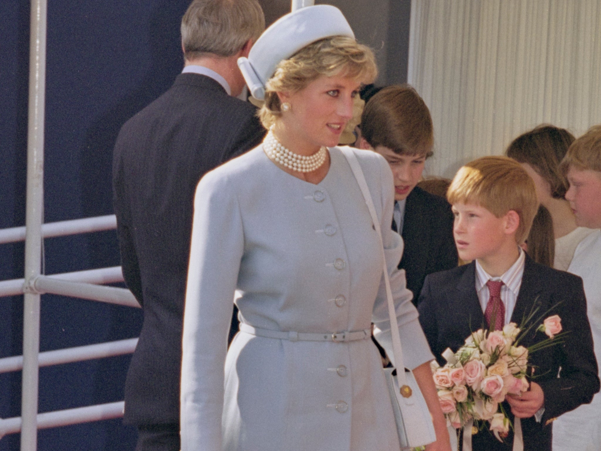 Princess Diana in 1995 with a young Prince William and Prince Harry in the background