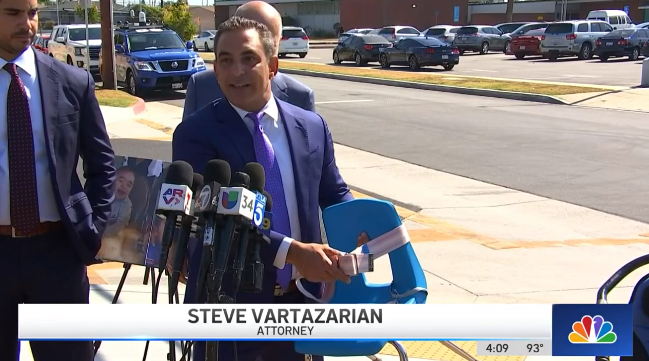 Steve Vartazarian, the family’s attorney, shows the chair with the gait belt that strapped the 8 year old into his seat before he suffered a fatal fall back in 2017 during a press conference on Wednesday