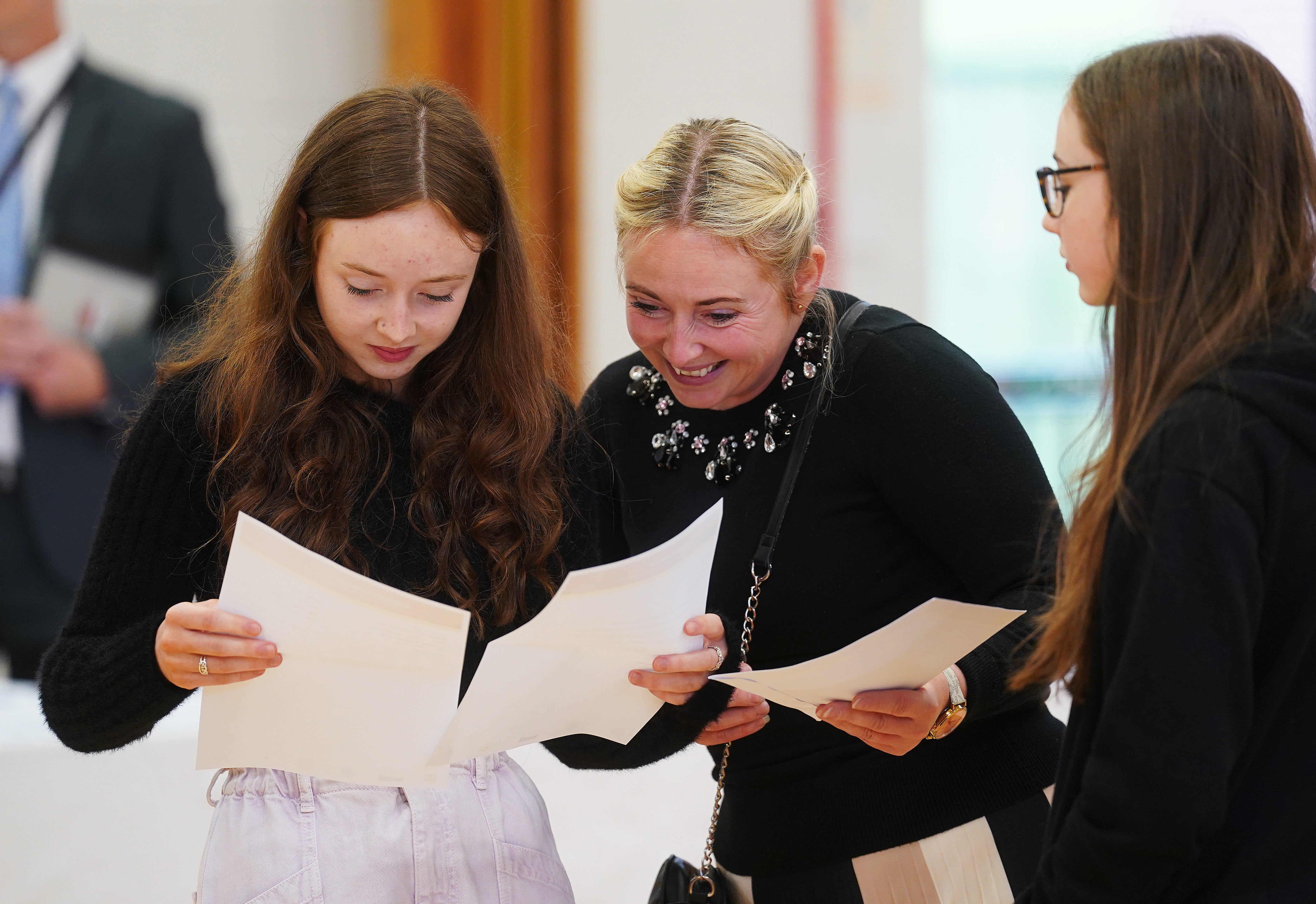 Jessica McGeown (left) opens her A-level results with her mother Samantha McGeown at Lagan College, Belfast (PA)