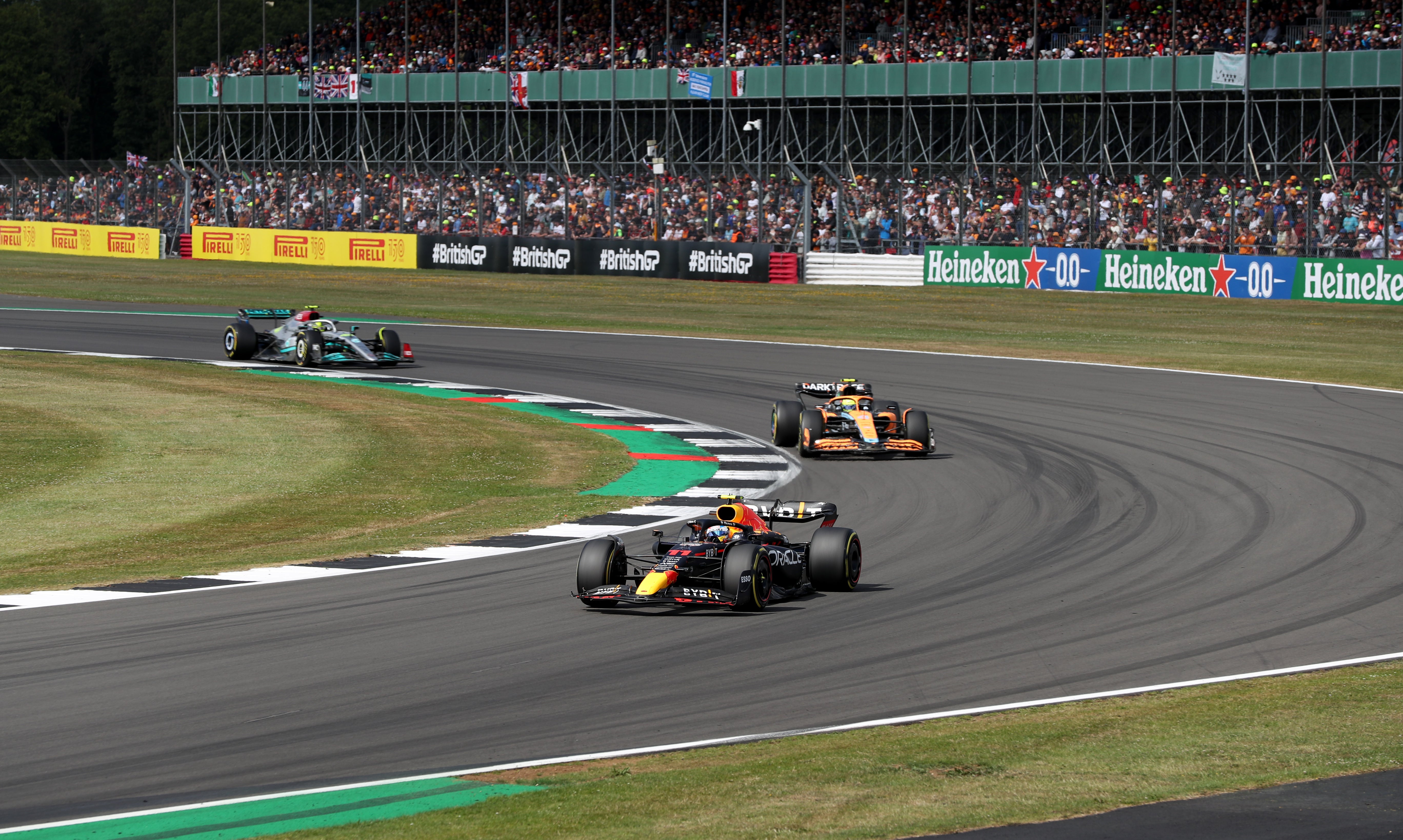 Red Bull’s Sergio Perez leading McLaren’s Lando Norris and Mercedes Lewis Hamilton during the British Grand Prix 2022 at Silverstone, Towcester (Bradley Collyer/PA)