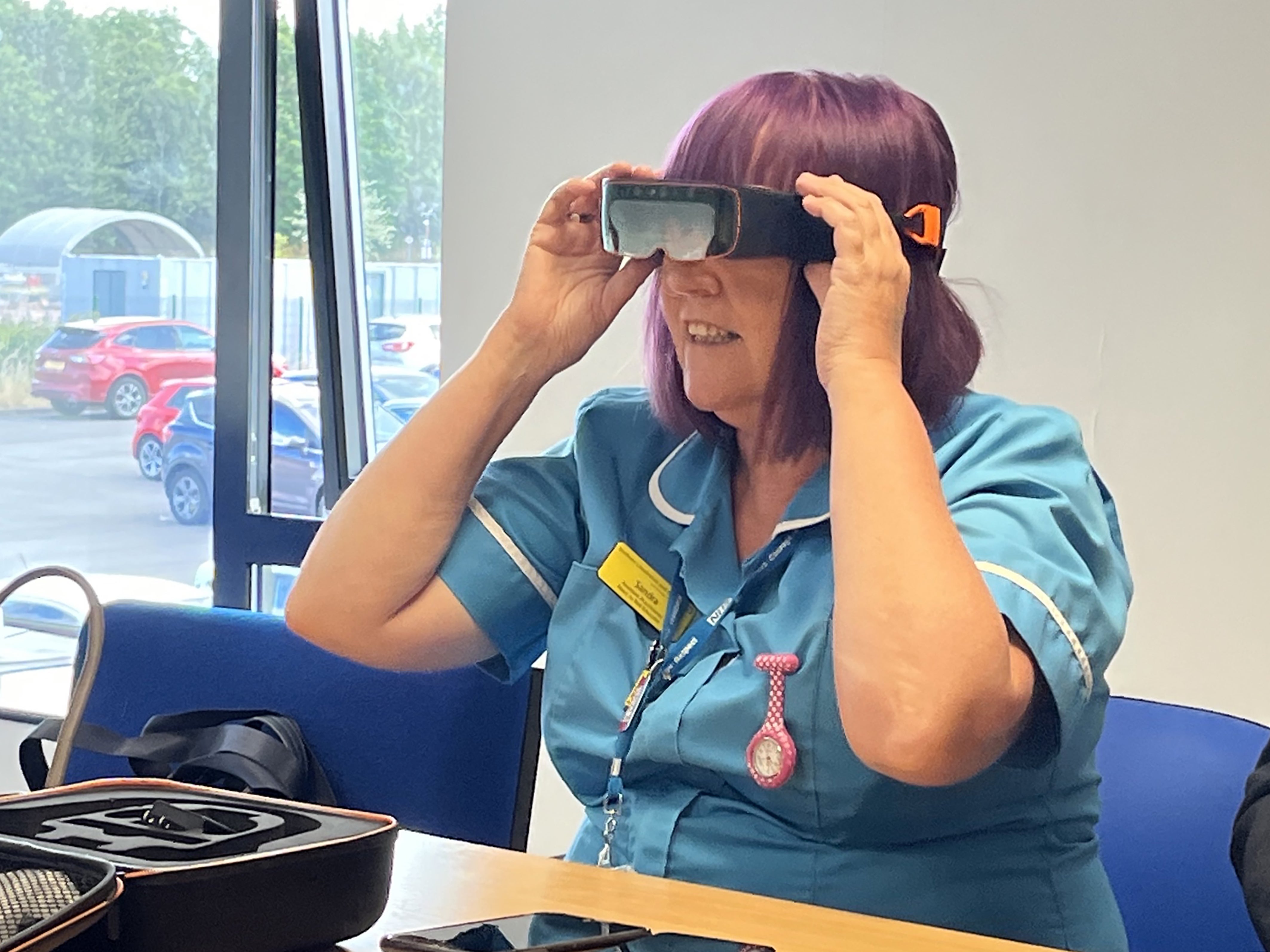 A nurse wearing an NHS hi-tech goggle which is being used on home visits (NHS England/PA)