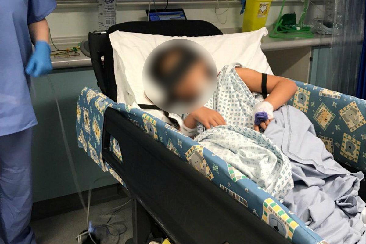 The girl in a bed at Worcestershire Royal Hospital after she was attacked by the dog