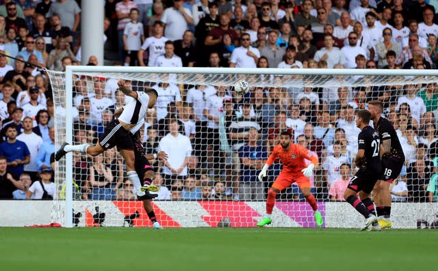 <p>Mitrovic guides his header past Brentford goalkeeper David Raya to claim all three points for Fulham </p>