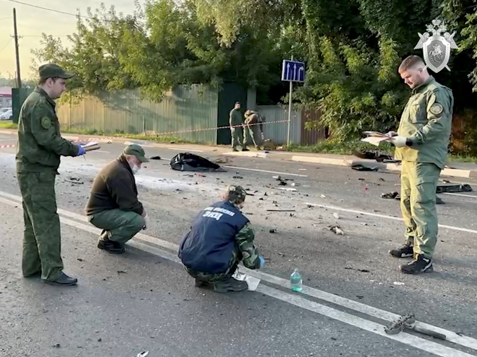 Investigators at the site of the car blast on Sunday