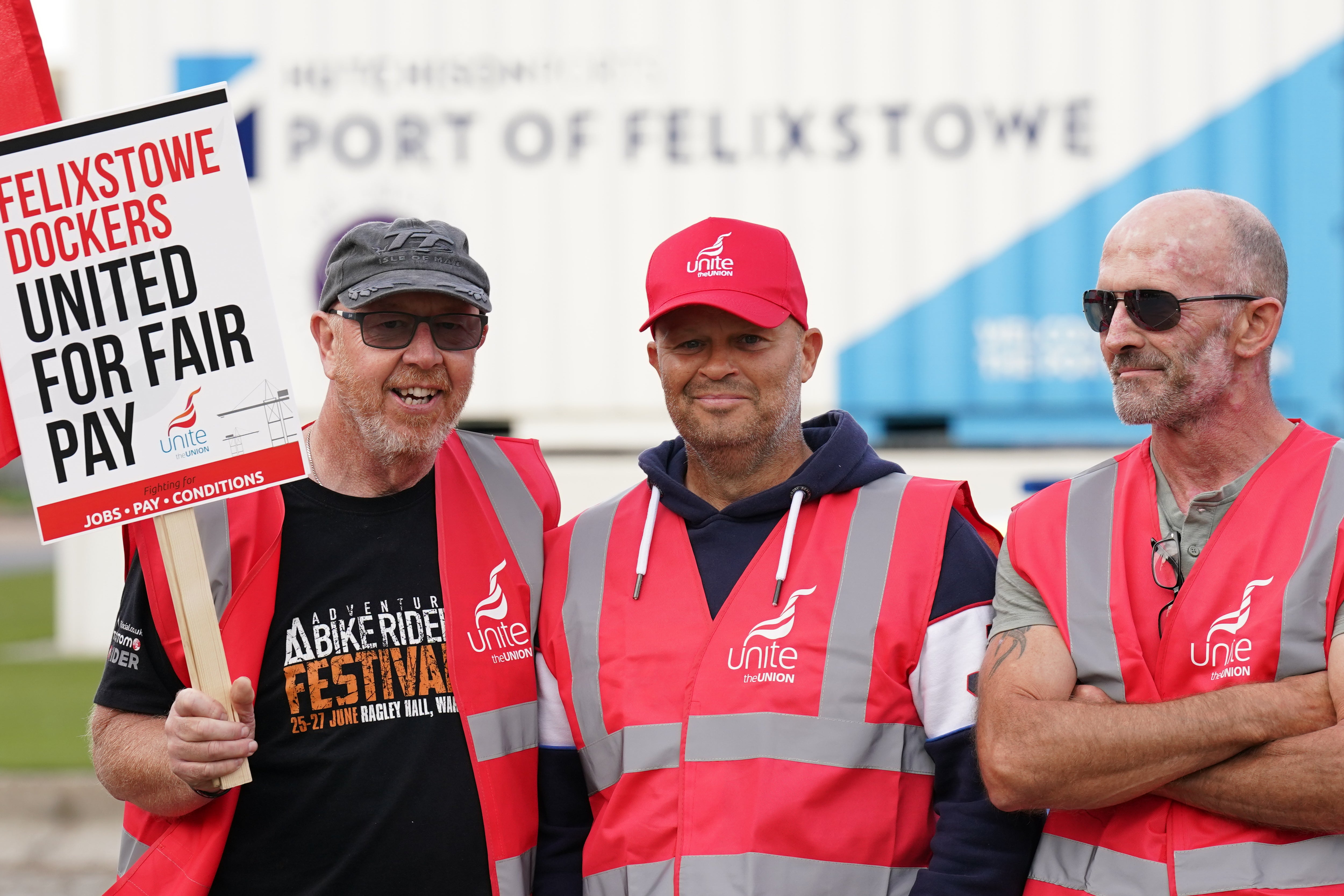 Members of the Unite union man a picket line at one of the entrances to the Port of Felixstowe in Suffolk (Joe Giddens/PA)