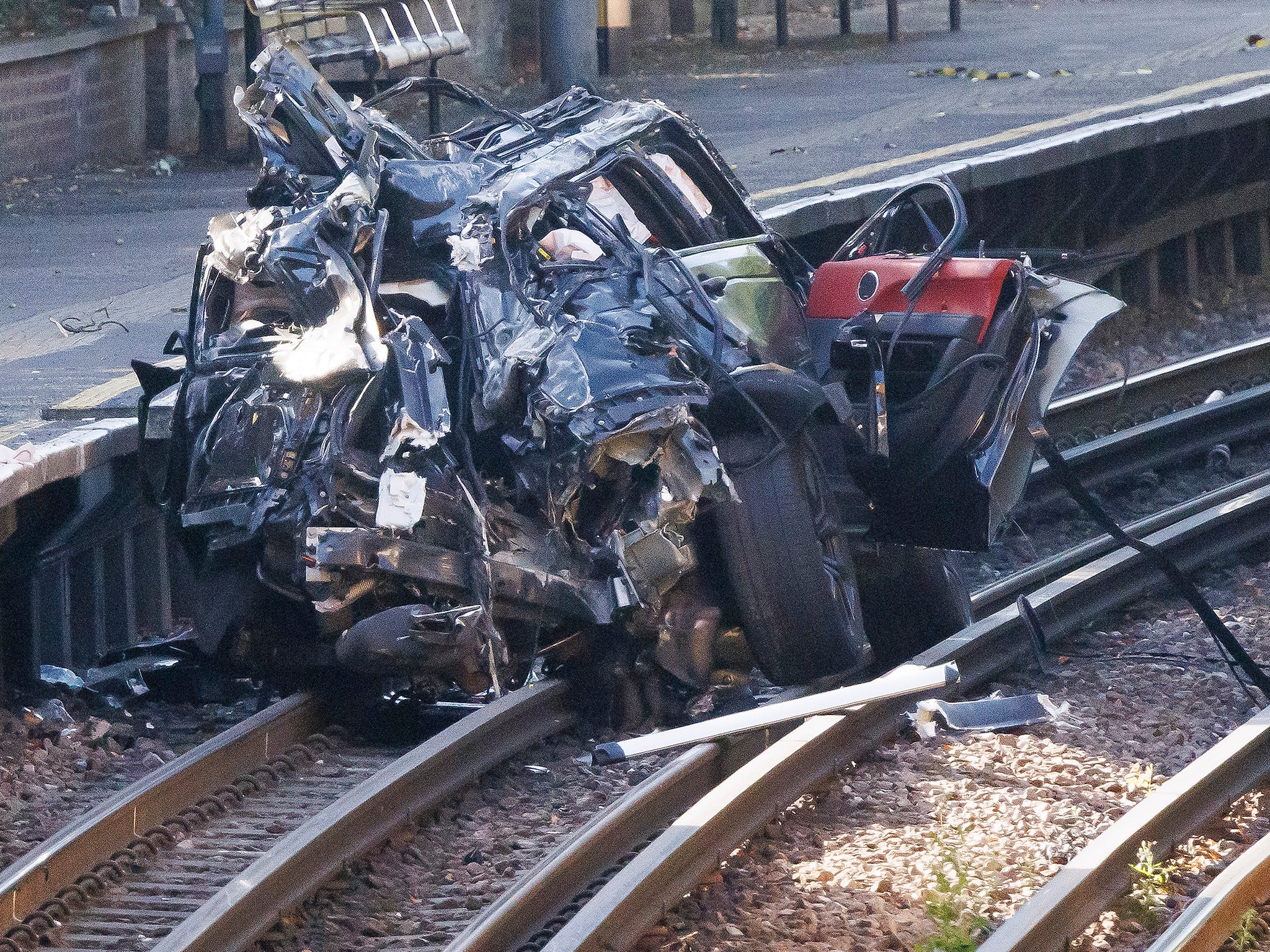 The wreckage of one of the vehicles on the train tracks