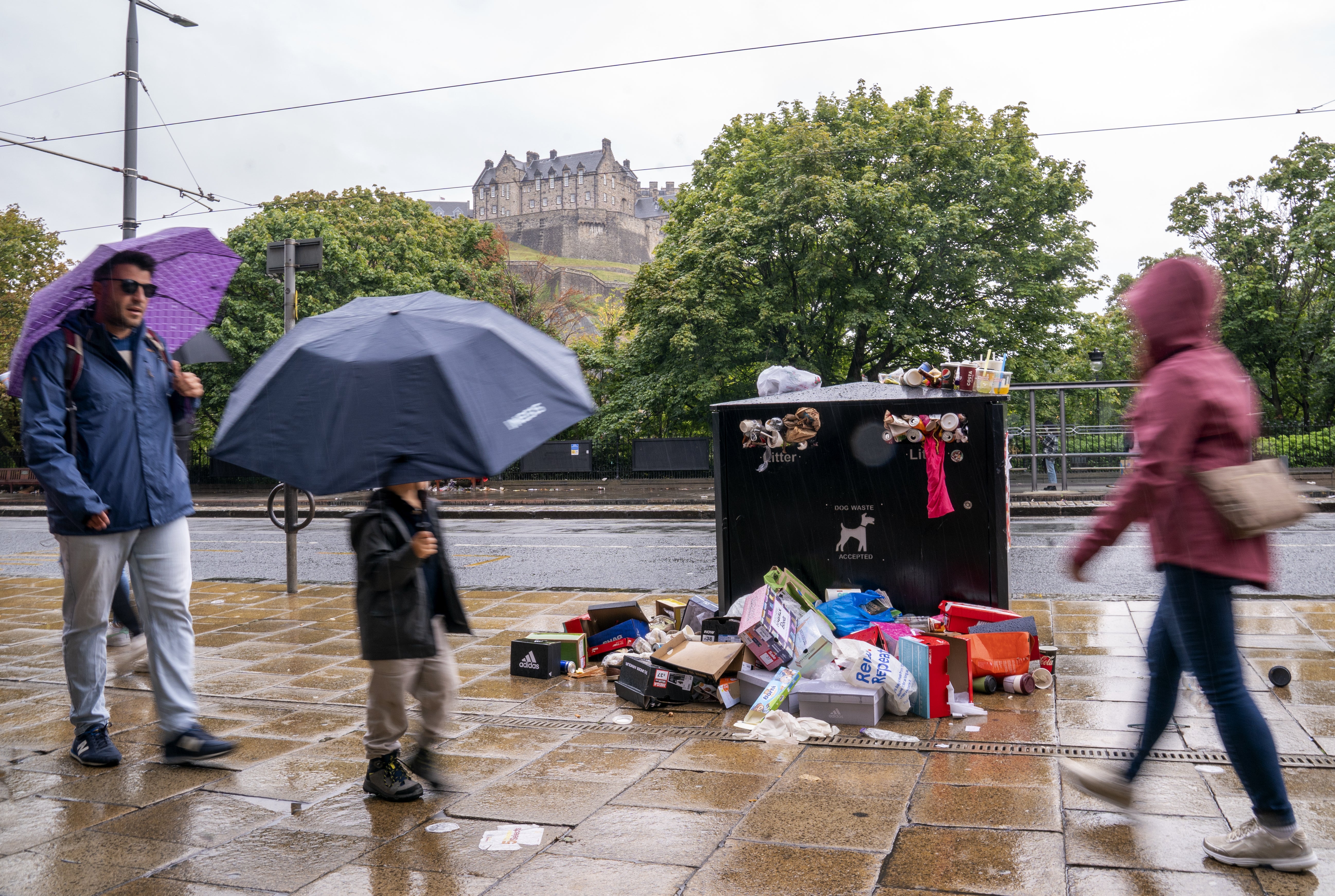 Bins overflowing with litter along Princes Street in Edinburgh city centre (Jane Barlow/PA)