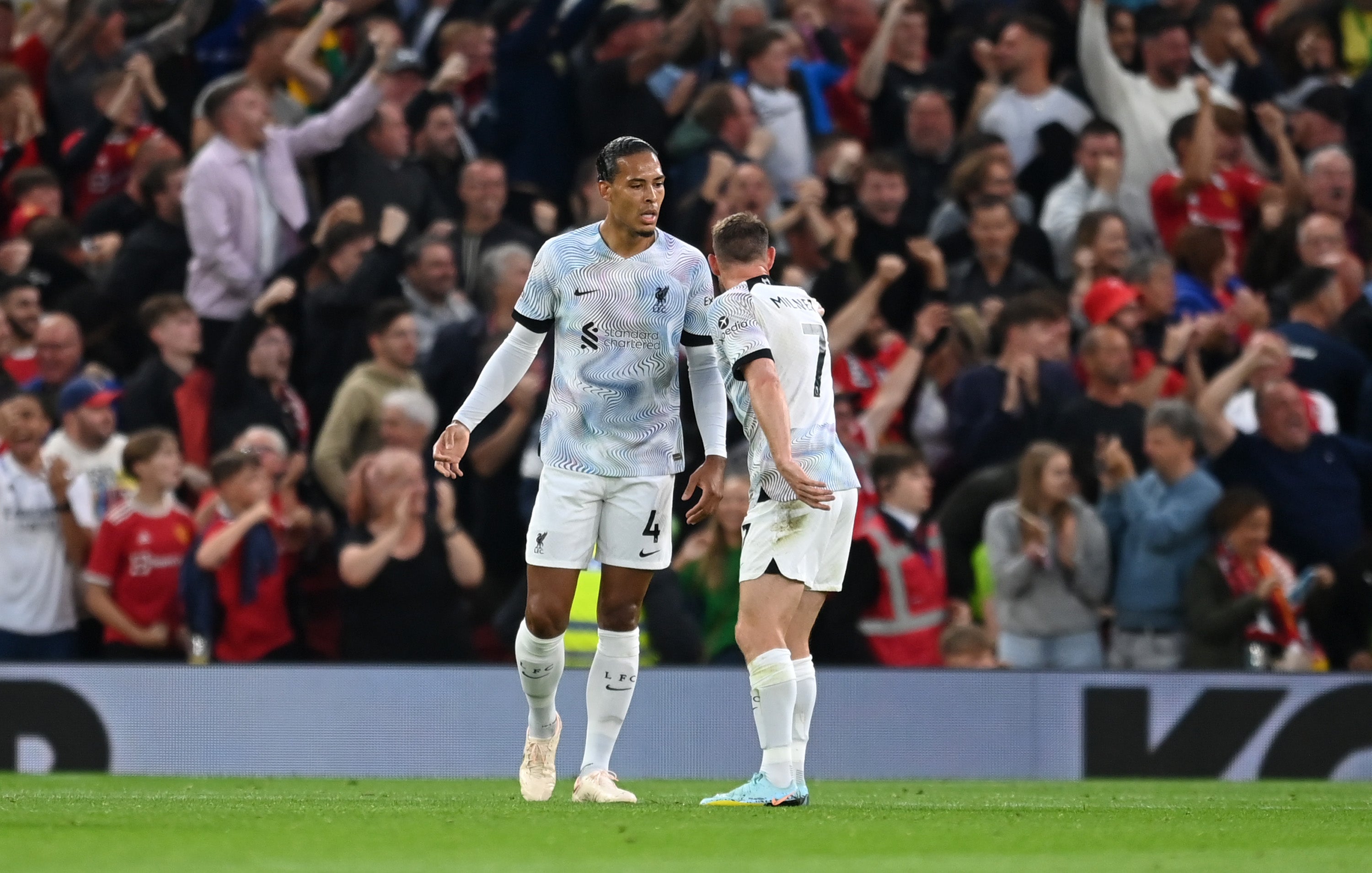 James Milner and Virgil van Dijk argue on the pitch