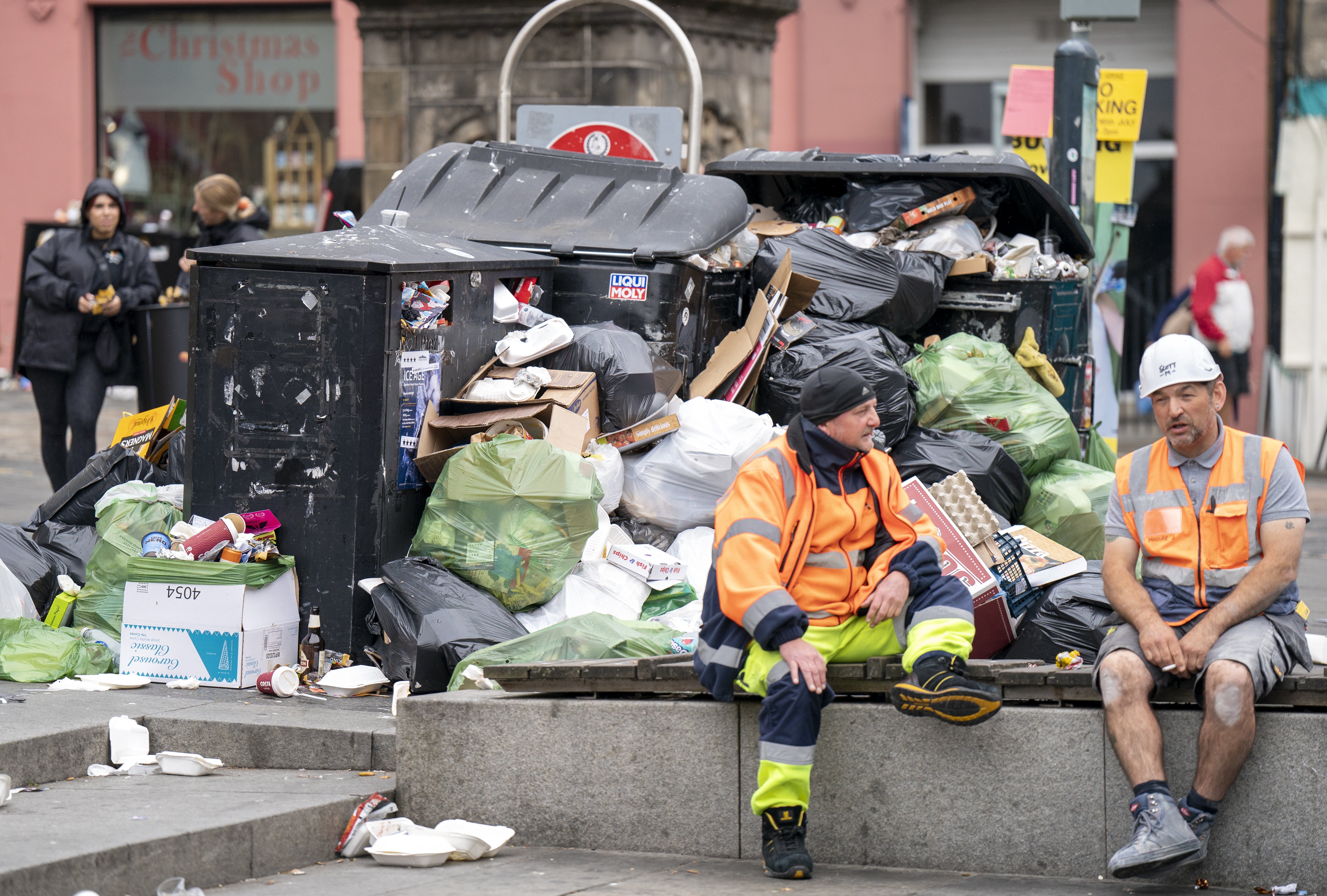 Bins and litter in the Grassmarket in Edinburgh city centre as cleansing workers from the City of Edinburgh Council are on the fourth day of eleven days of strike action. Workers at waste and recycling depots across the city have rejected a formal pay offer of 3.5 percent from councils body Cosla. Monday August 22, 2022 (Jane Barlow/PA)