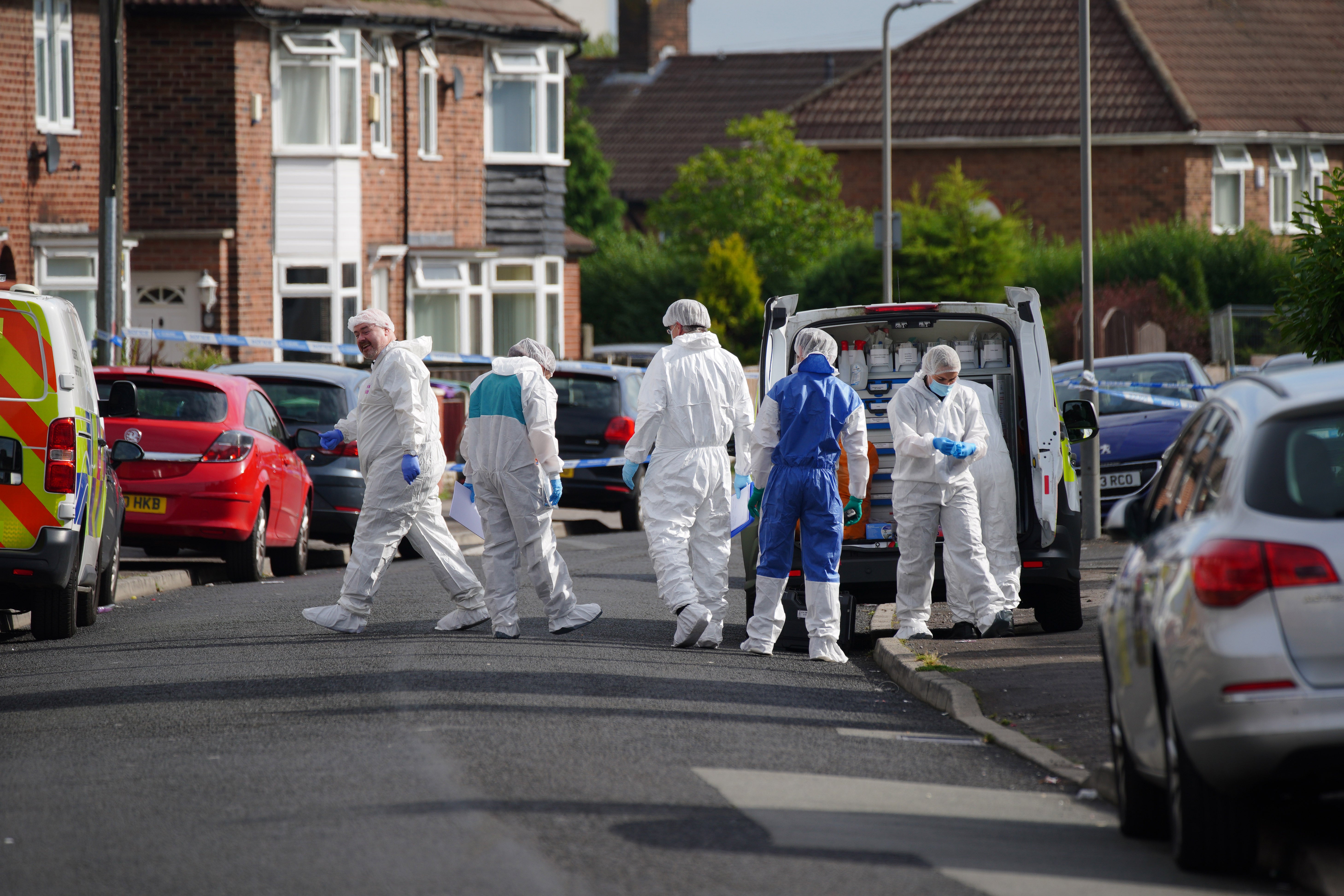 Forensic officers near to the scene in Knotty Ash, Liverpool, where the nine-year-old girl was fatally shot