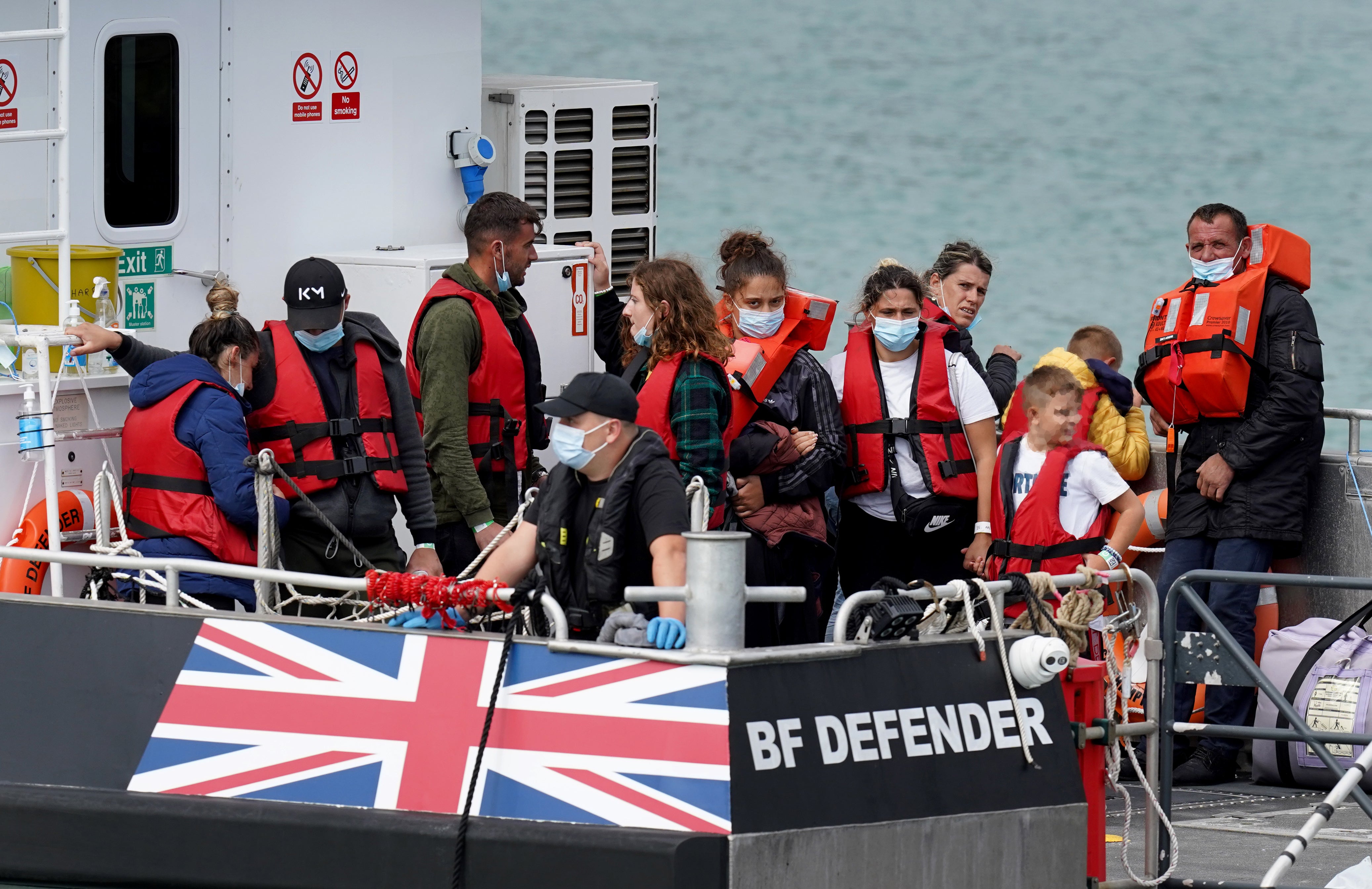 EDITORS NOTE Children’s faces have been pixelated as the PA Picture Desk has been unable to gain the necessary permission to photograph a child under 16 on issues involving their welfare. A group of people thought to be migrants are brought in to Dover, Kent, onboard a Border Force Vessel, following a small boat incident in the Channel. Picture date: Tuesday August 23, 2022. (Gareth Fuller/PA)