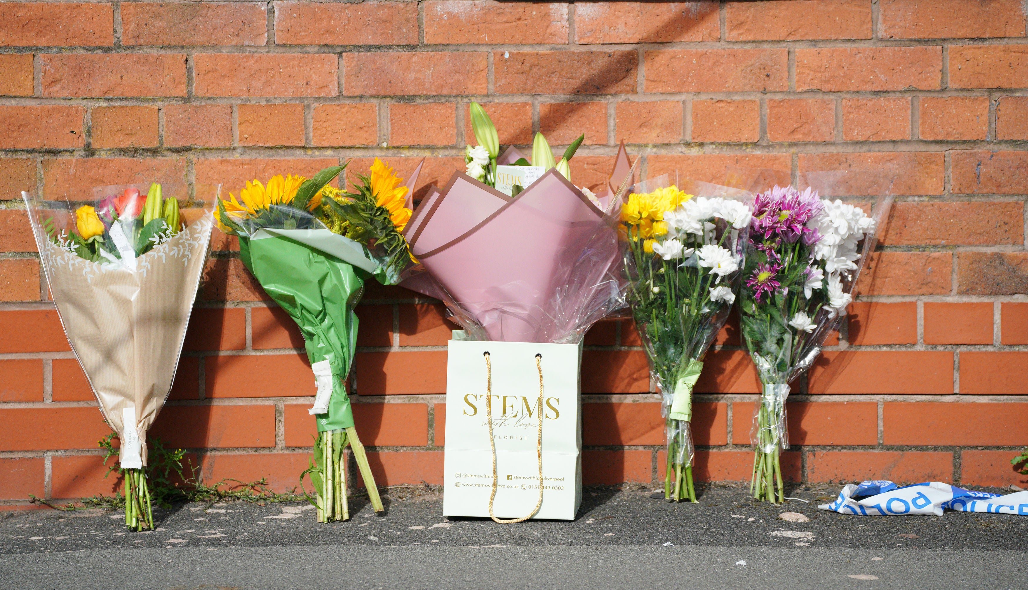 Flowers are left near to the scene in Kingsheath Avenue