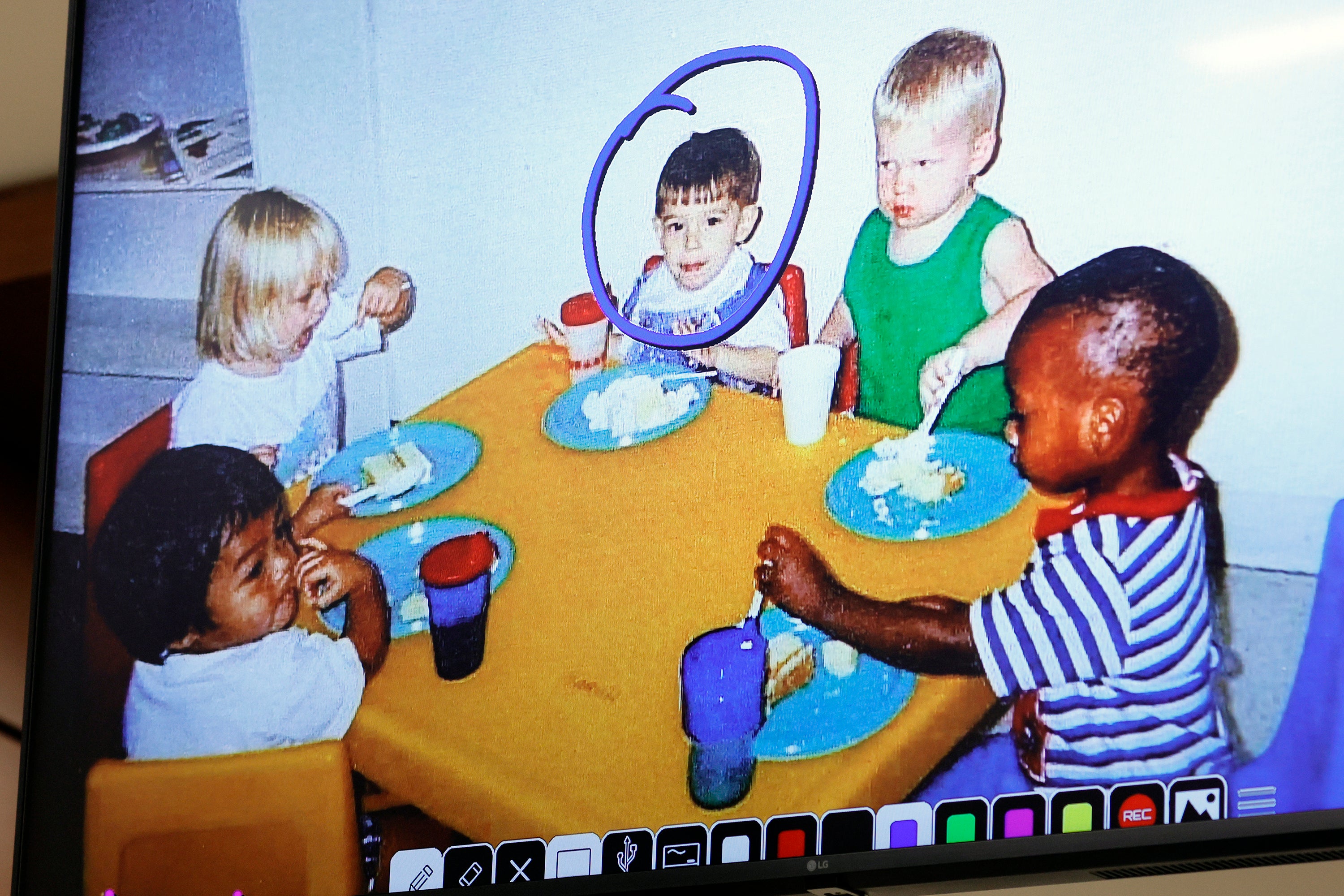 Nikolas Cruz, circled in blue, is shown with classmates in an undated photo from at Young Minds Learning Center