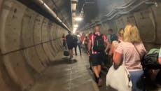 People walk through Eurotunnel after train breaks down inside