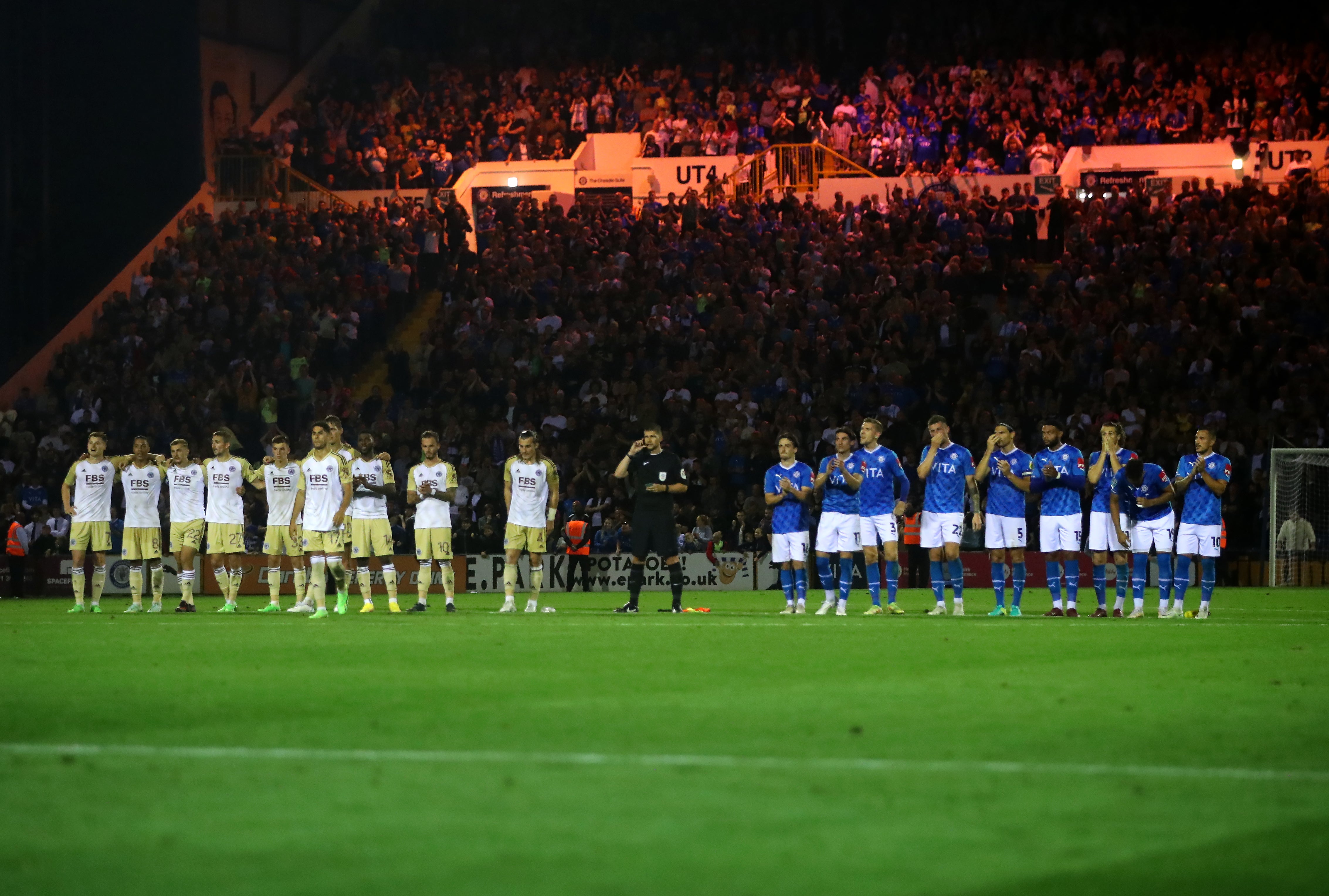 Players line up on the pitch during the penalty shootout (