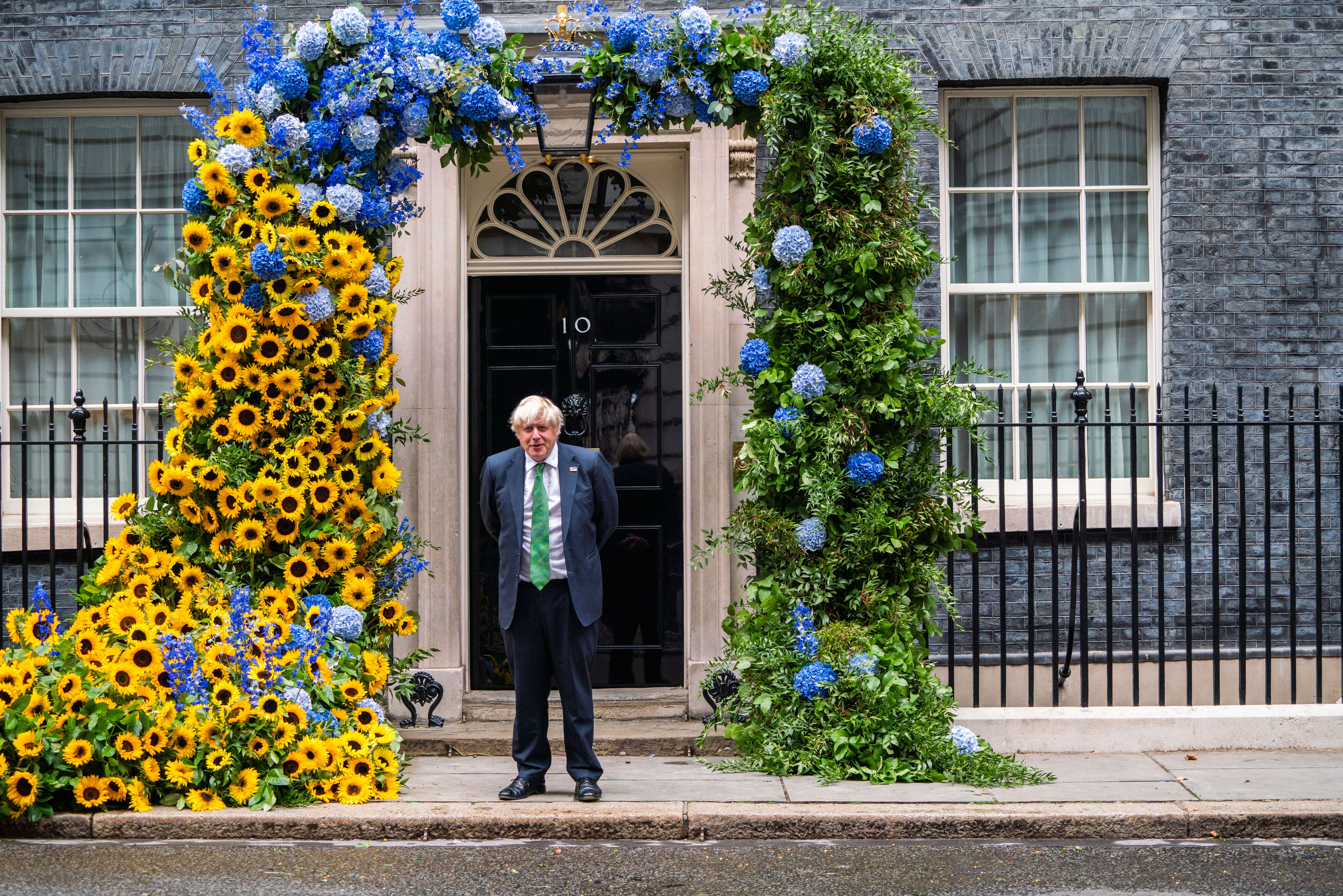 Boris Johnson outside the door of 10 Downing Street decorated with sunflowers the national symbol of Ukraine to mark Independence Day of Ukraine on 24 August