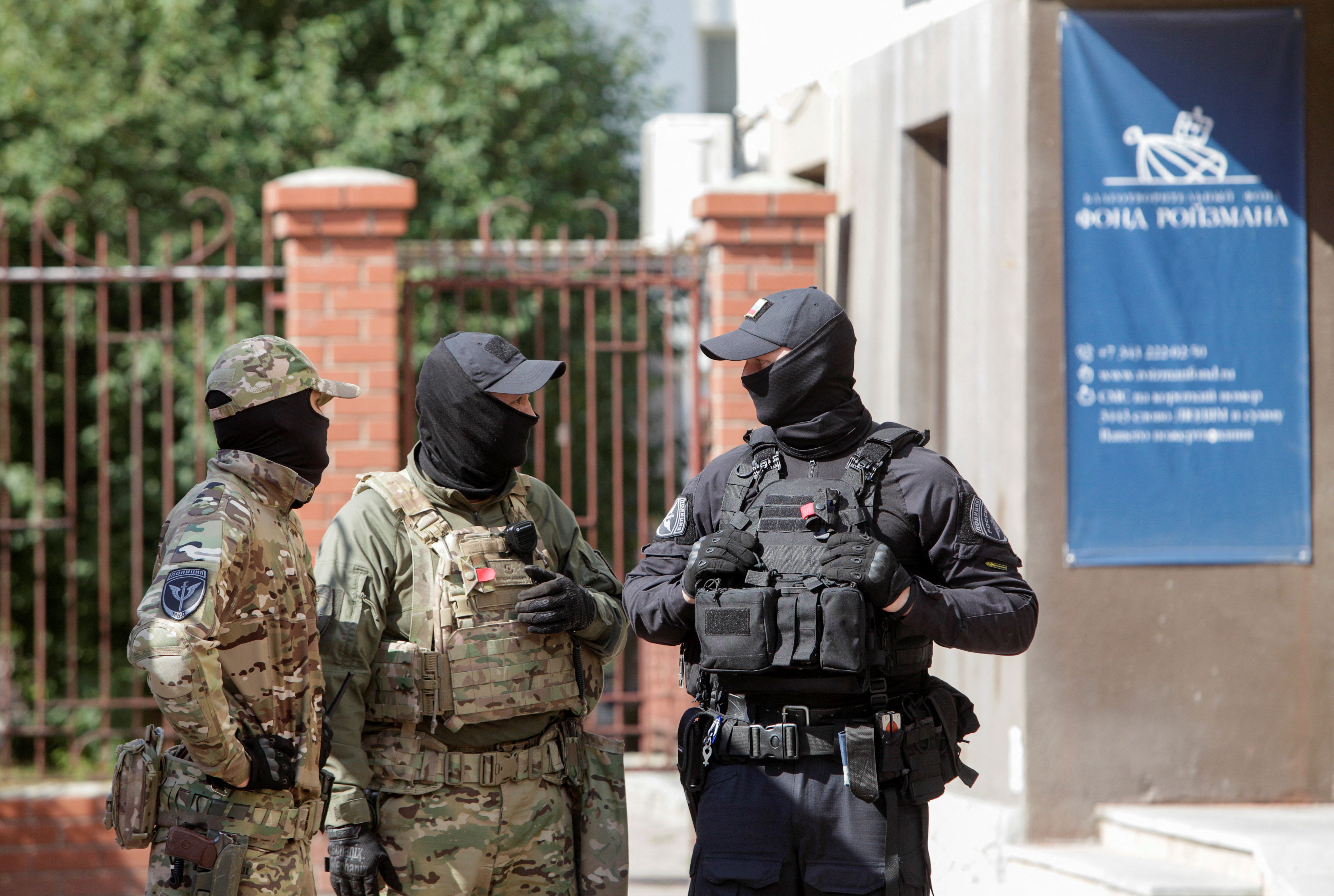 Officers stand guard outside the office of Yevgeny Roizman's charity fund in Yekaterinburg