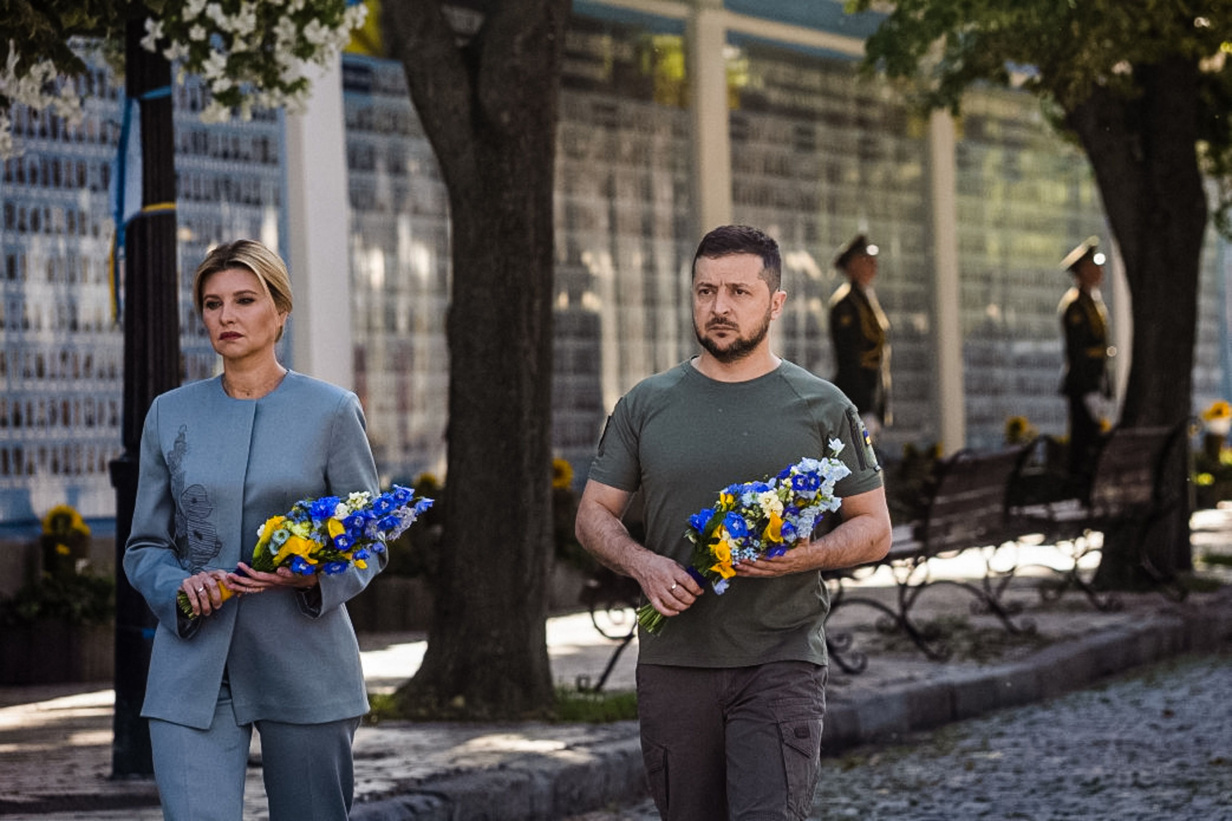 Volodymyr Zelensky (R) and his wife Olena attending a commemoration ceremony at a memorial wall