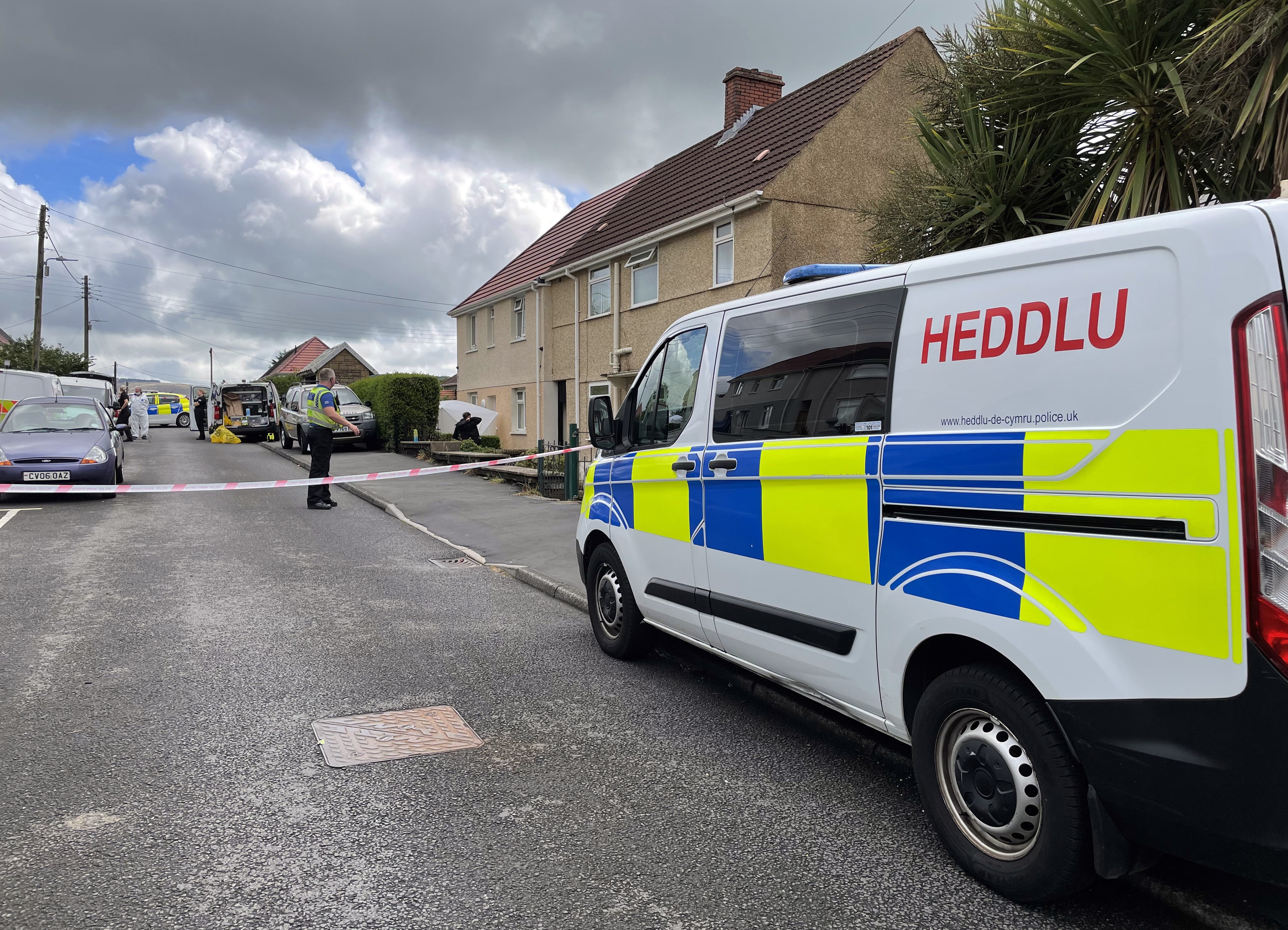 South Wales Police and forensic units at the scene where a 71-year-old woman was murdered outside her home on Tanycoed (Bronwen Weatherby/PA)