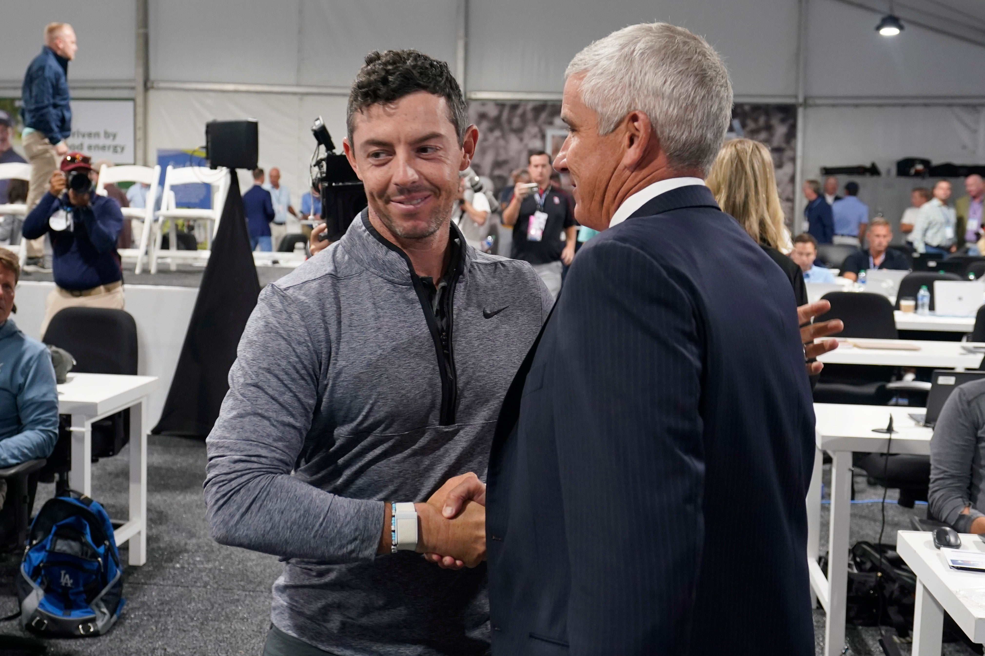 Rory McIlroy, left, shakes hands with PGA Tour commissioner Jay Monahan after a press conference at East Lake (Steve Helber/AP)