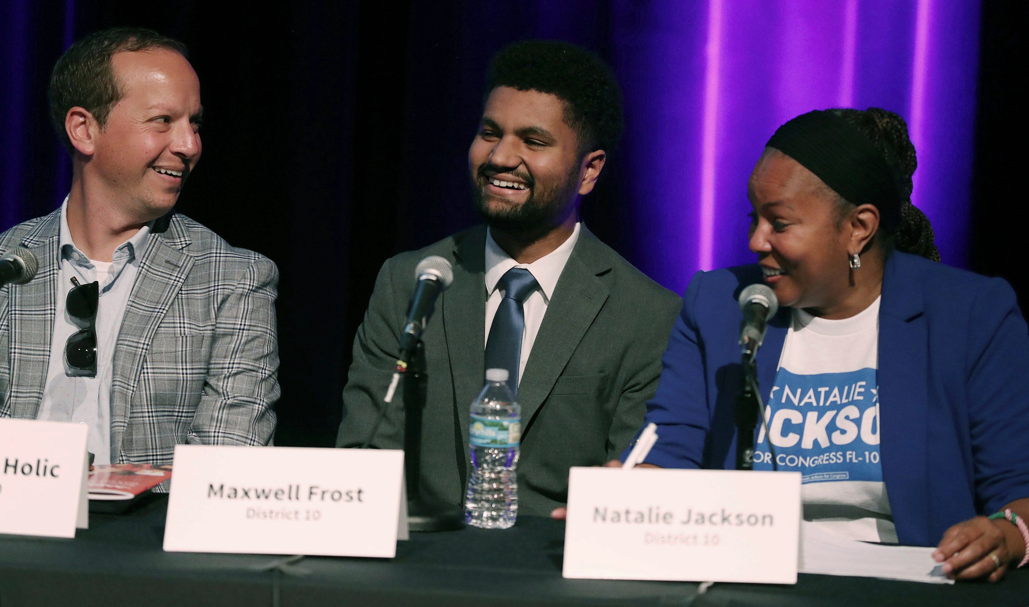 Jason Kyle Holic, from left, Maxwell Frost, and Natalie Jackson are pictured during "Decision 2022 Community Conversations With Congressional Candidates" panel discussion at the Orlando Science Center on Thursday, July 28, 2022, in Orlando, Fla. Frost, who campaigned on gun control, Medicare for all and criminal justice reform, beat out a crowded cast of Democrats who ran for Florida's 10th Congressional District, an Orlando area seat considered to be a liberal stronghold. (Stephen M. Dowell/Orlando Sentinel via AP)