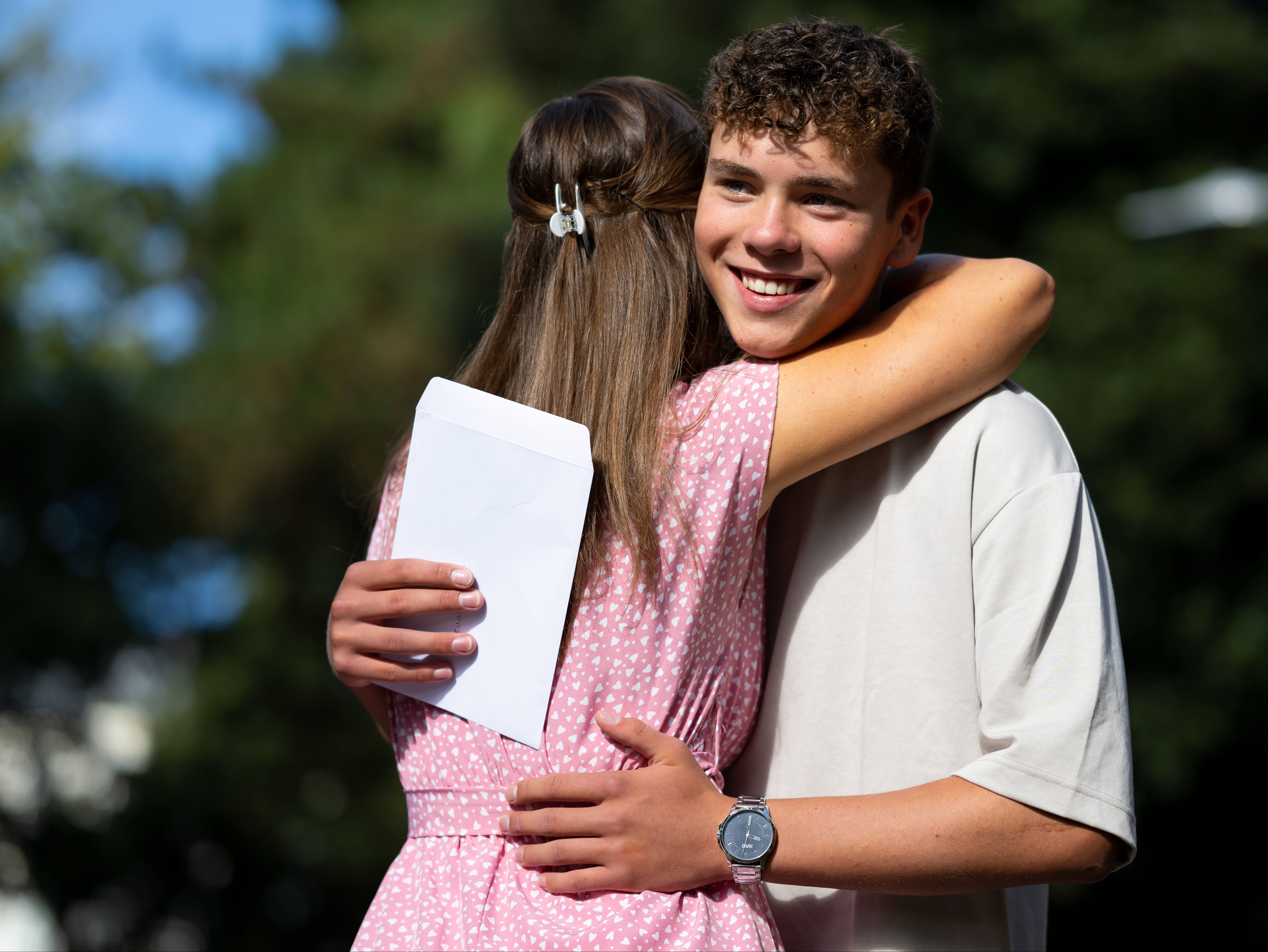 Ieuan Nelson hugs his mum after opening his GCSE results in Wales