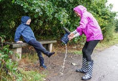 In Pictures: Umbrellas at the ready as dry weather gives way to downpours