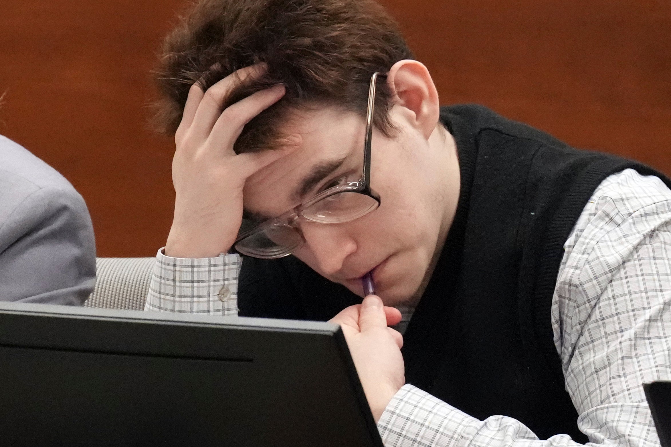 Nikolas Cruz chews on a pen as he sits in court at his trial this week