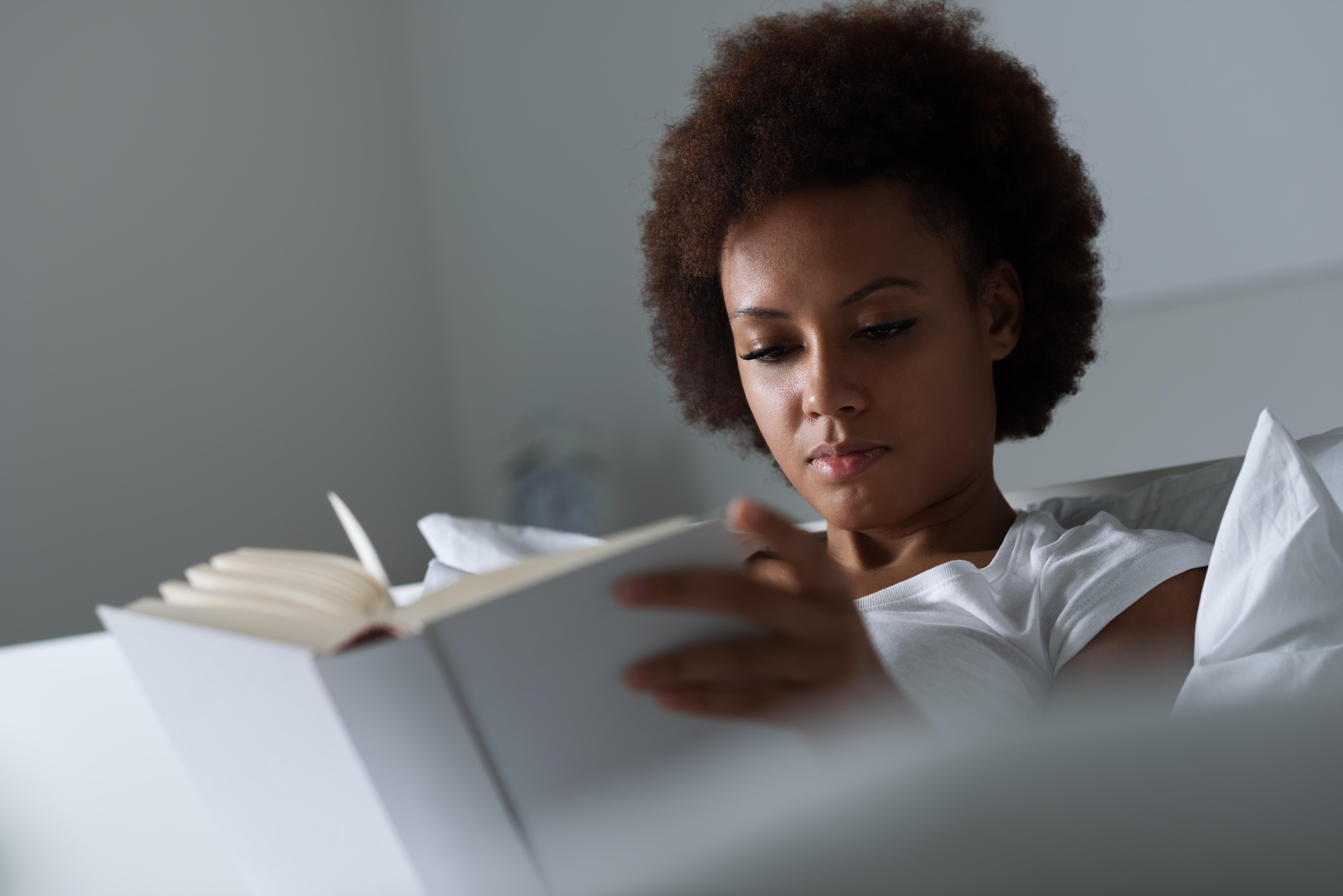 Reading in bed instead of doomscrolling could help you switch off (Alamy/PA)