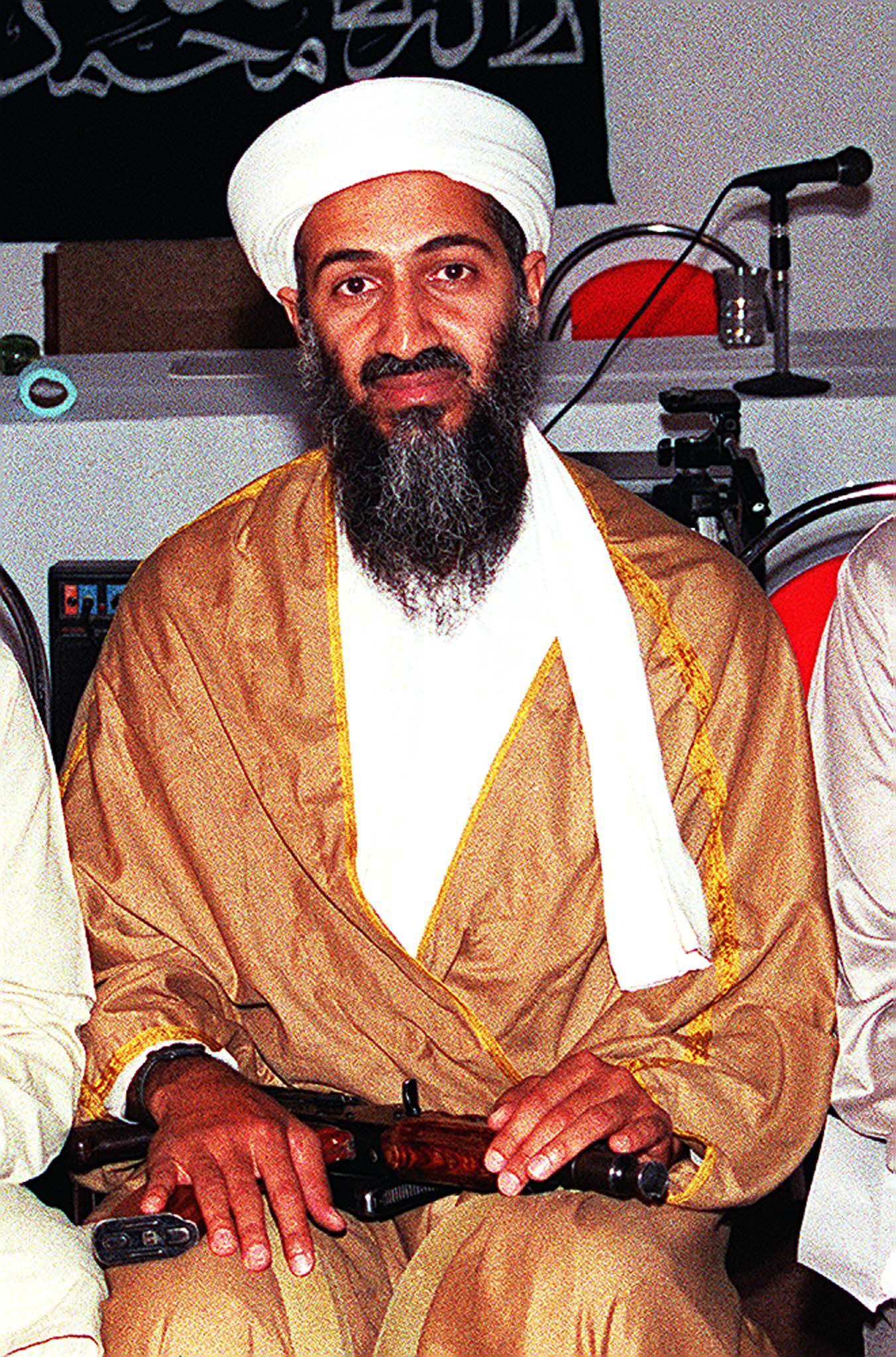 Osama bin Laden attends a meeting with a Kalashnikov on his lap