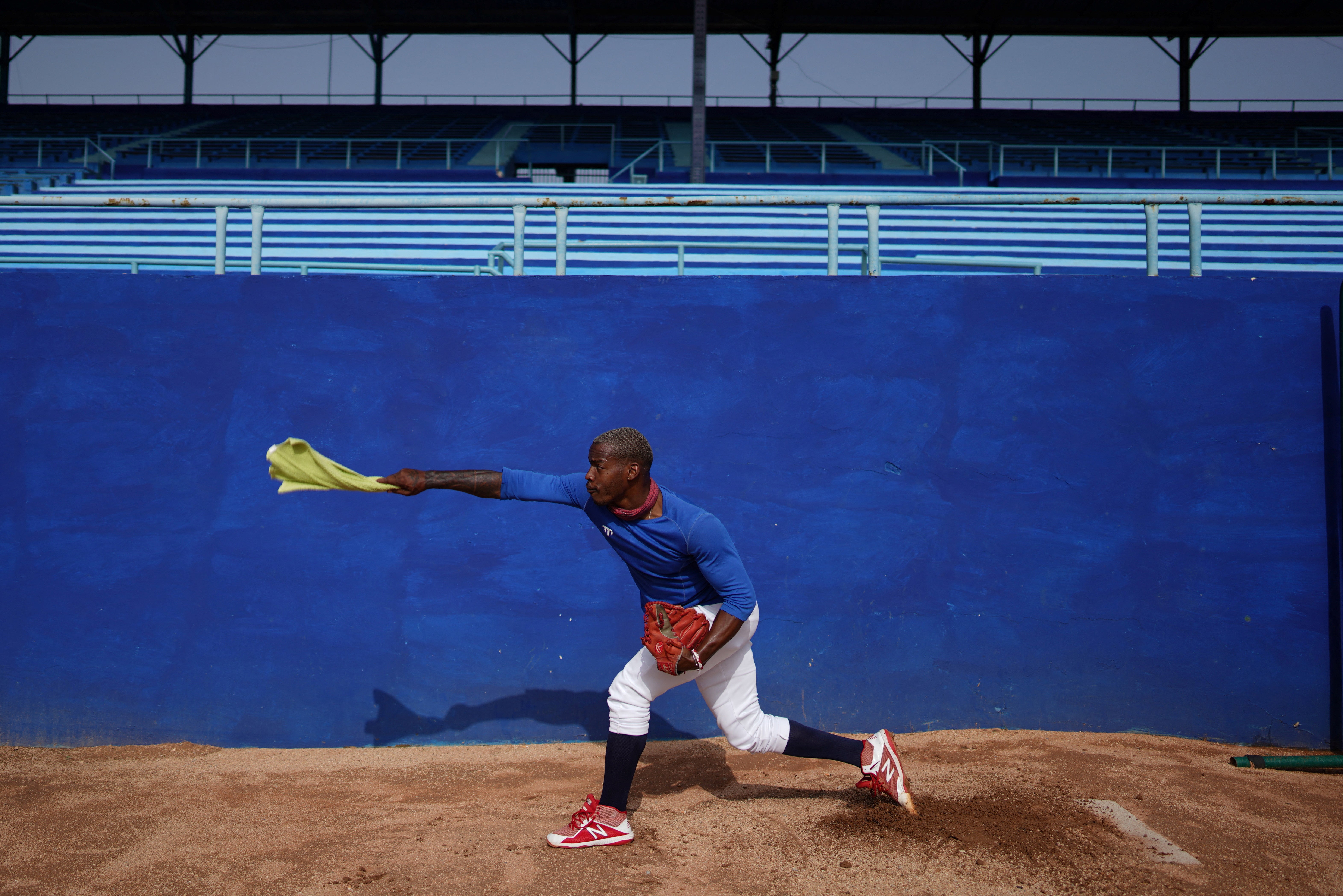 Industriales baseball team member David Mena practises before a match at the Latinoamericano Stadium