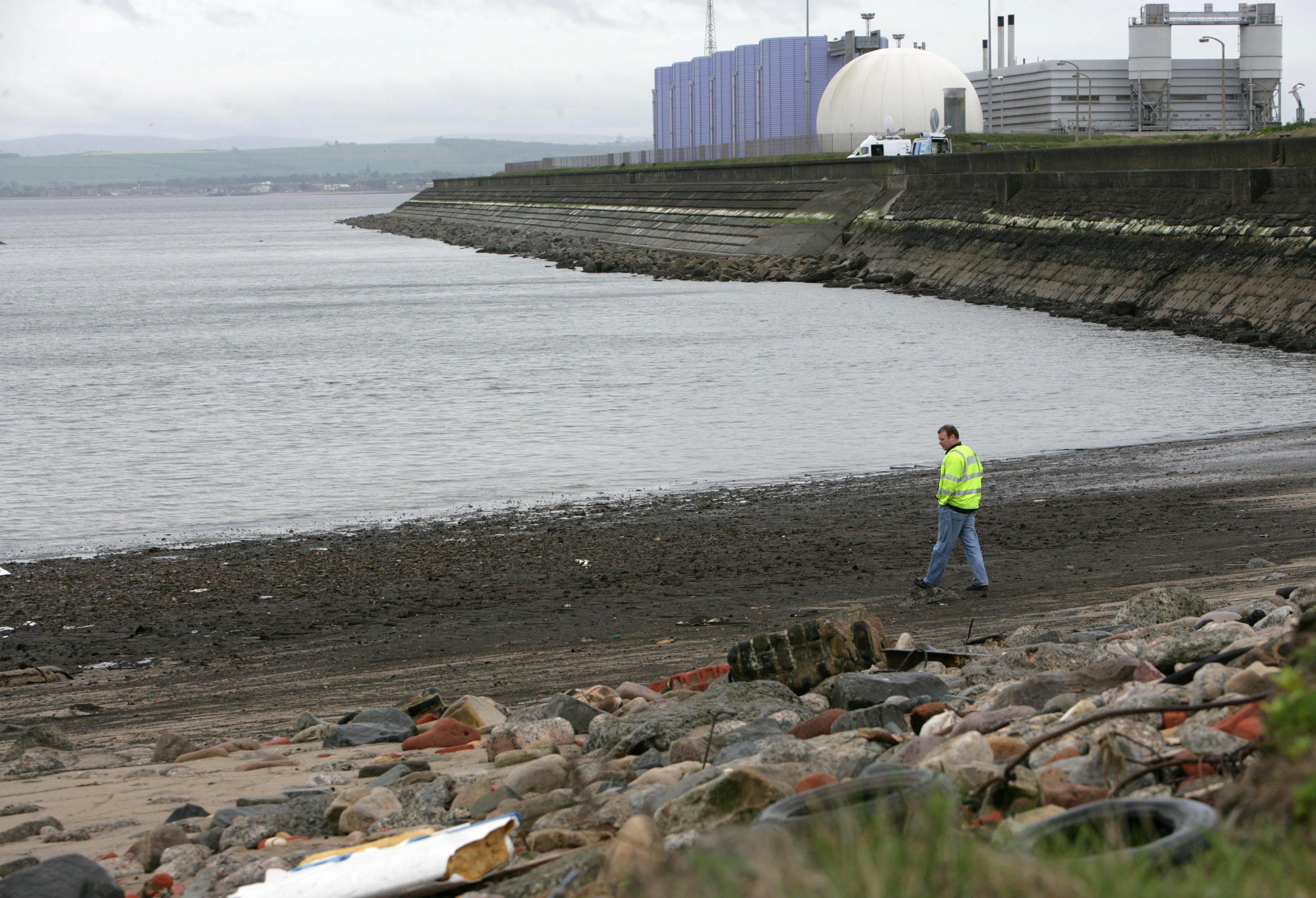 A Scottish Water official examines Seafield beach and the outflow pipe where raw sewage was pumped into the Forth Estuary (Toby Williams/PA)