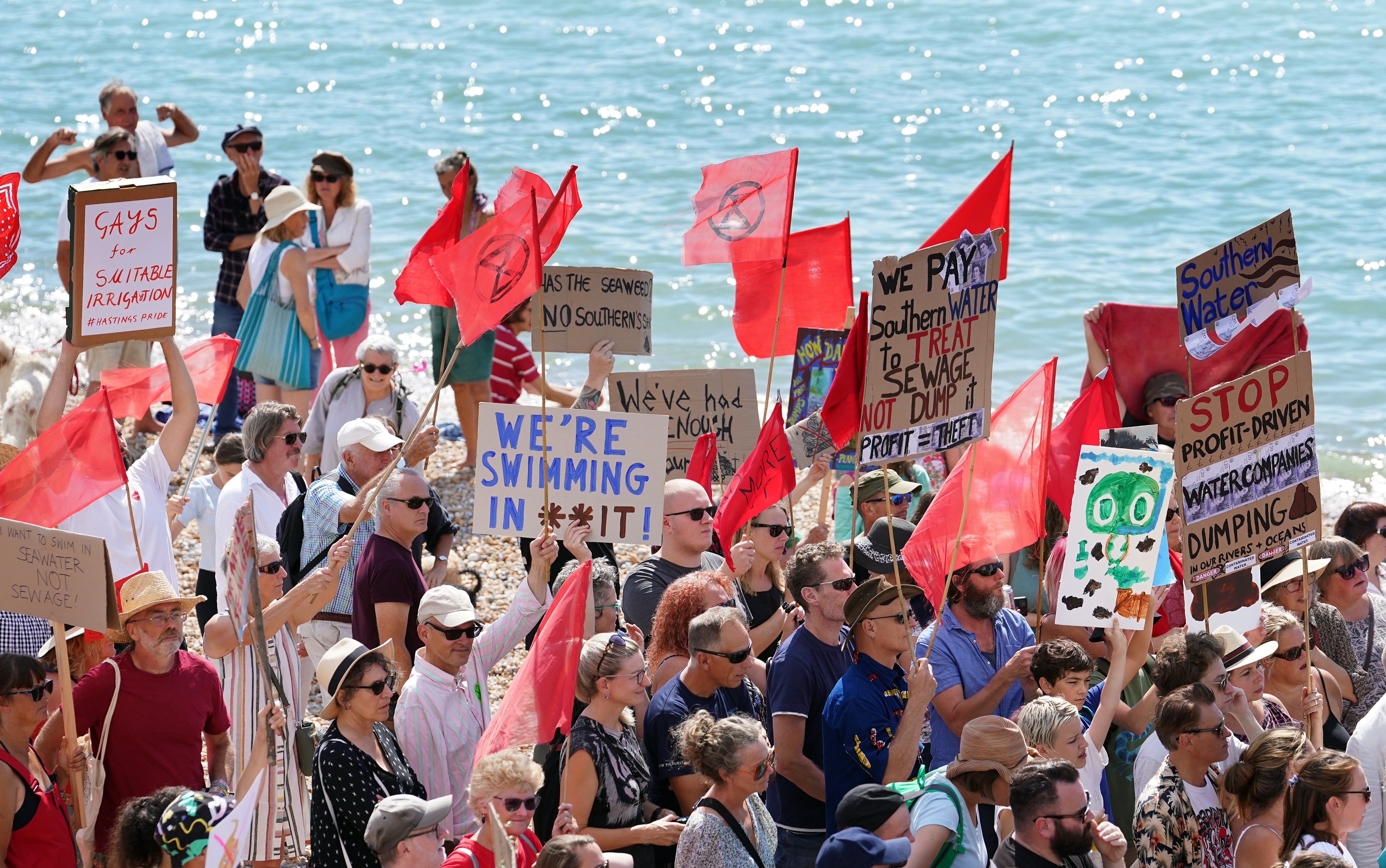 Members of the public and Hastings and St Leonards Clean Water Action protest against raw sewage release incidents on the beach in St Leonards, Sussex