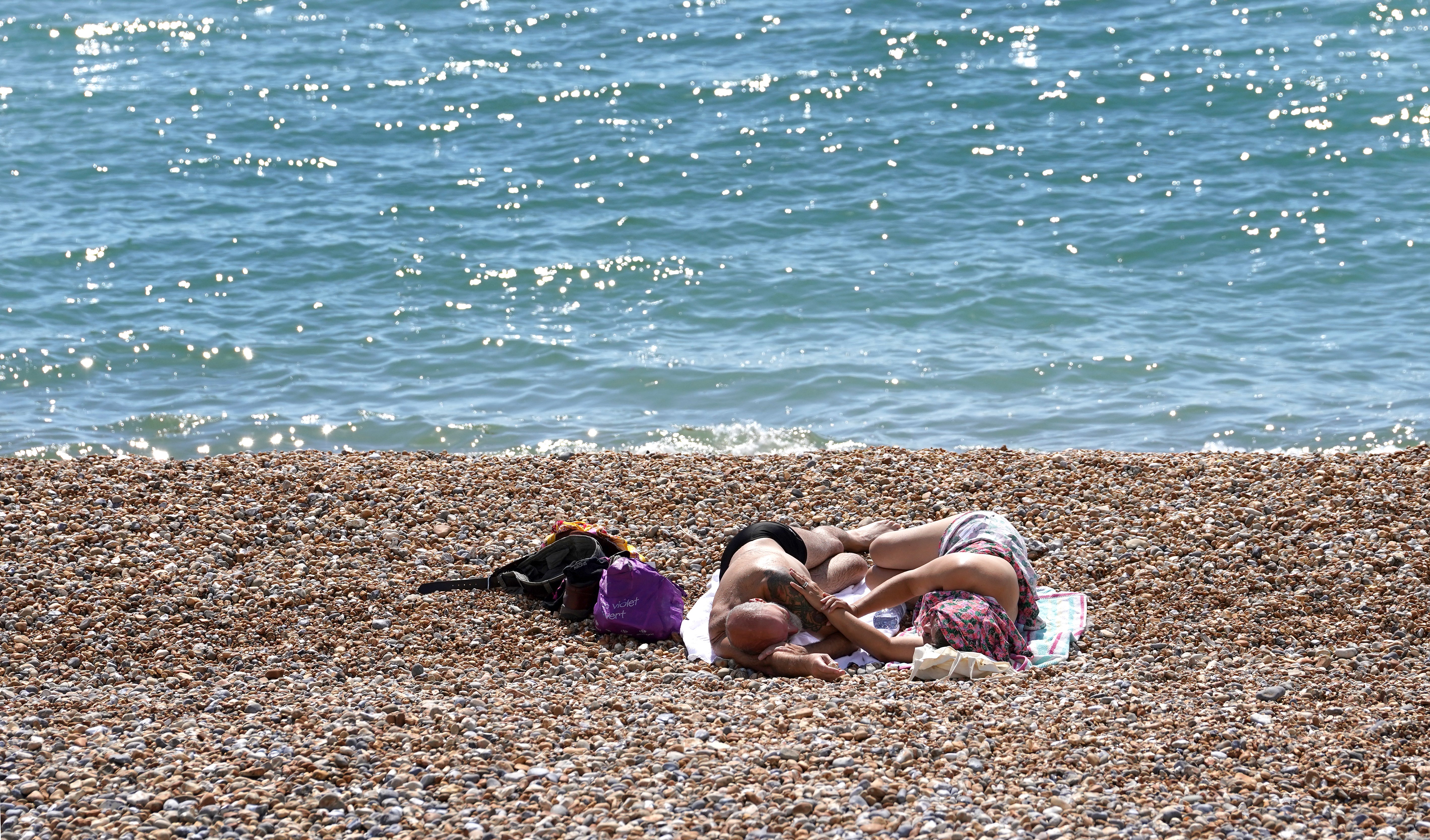 People enjoy the warm weather on the beach in St Leonards, Sussex