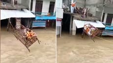 Pakistan floods: Stranded family saved after sliding on bed frame across water