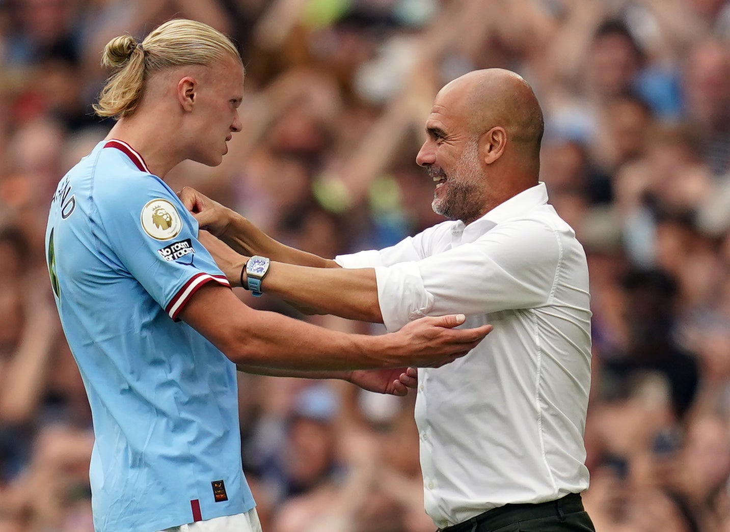 Erling Haaland, left, celebrates with Pep Guardiola (Nick Potts/PA)