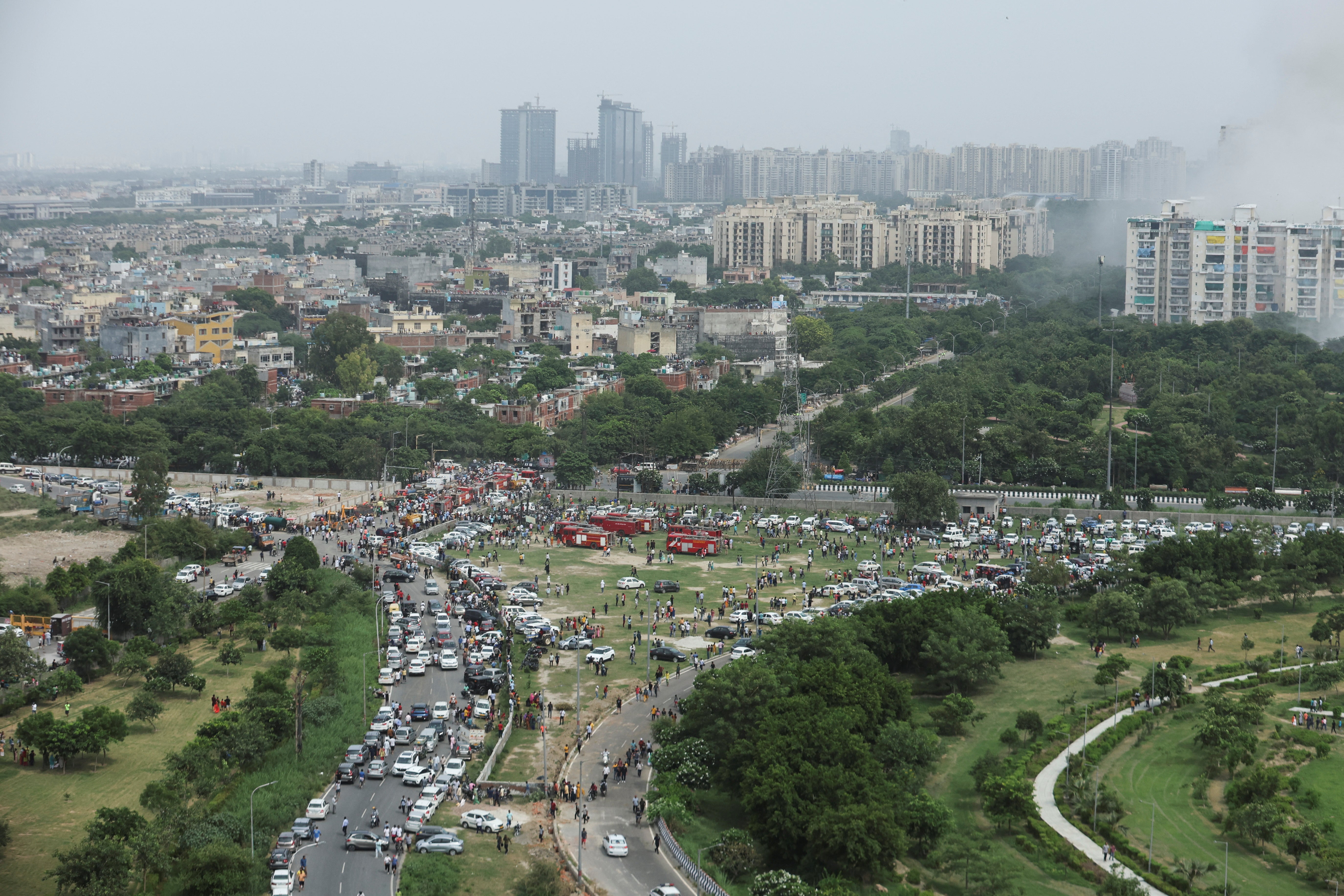 Several onlookers on foot and in vehicles leave after watching Supertech demolition spectacle