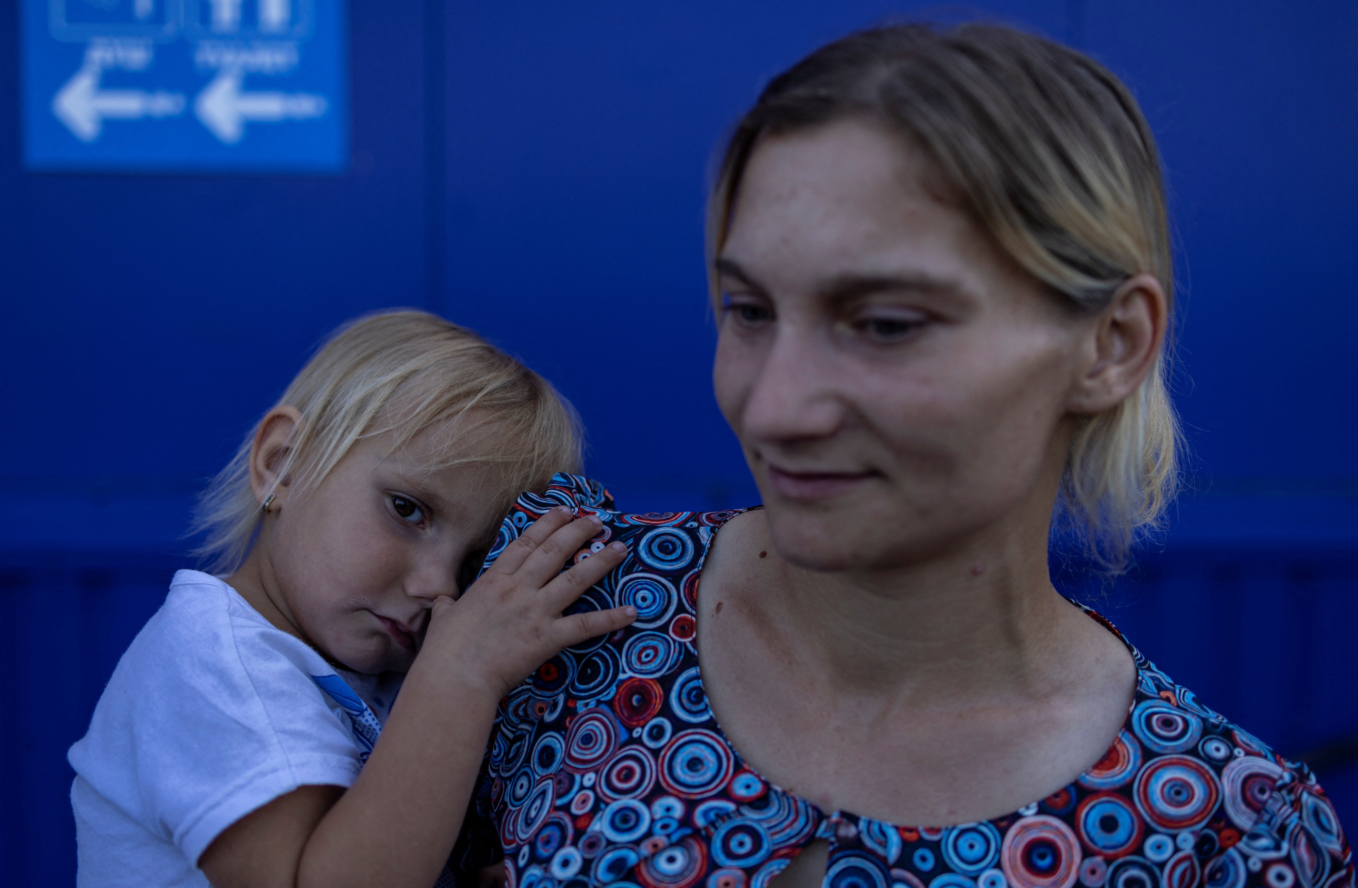 Tatiana Pidlesina and her two-year-old daughter Ulyana wait at a relief centre in Zaporizhzhia to be transferred to another part of Ukraine