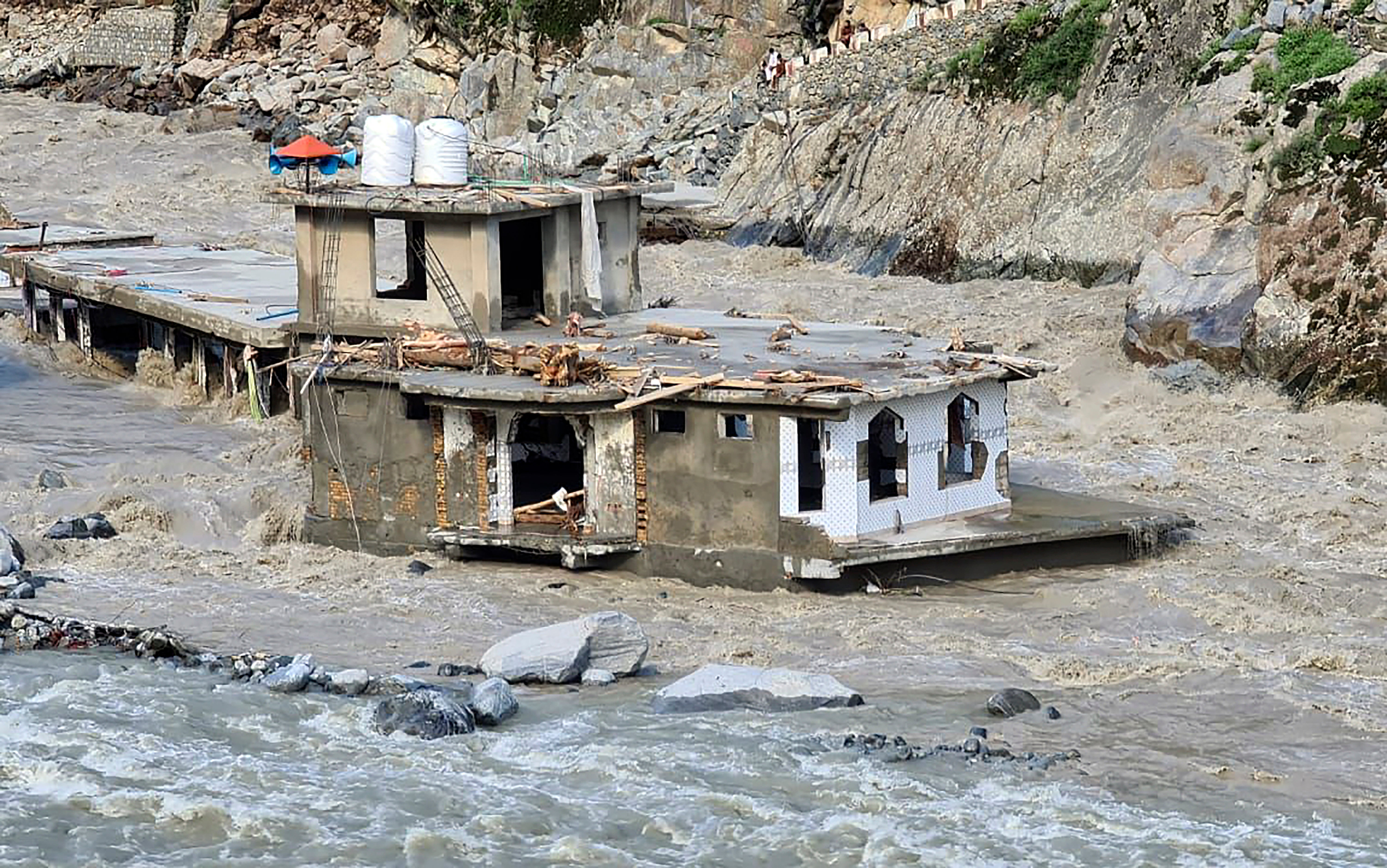 A damaged mosque is surrounded by floodwaters in Bahrain, Pakistan