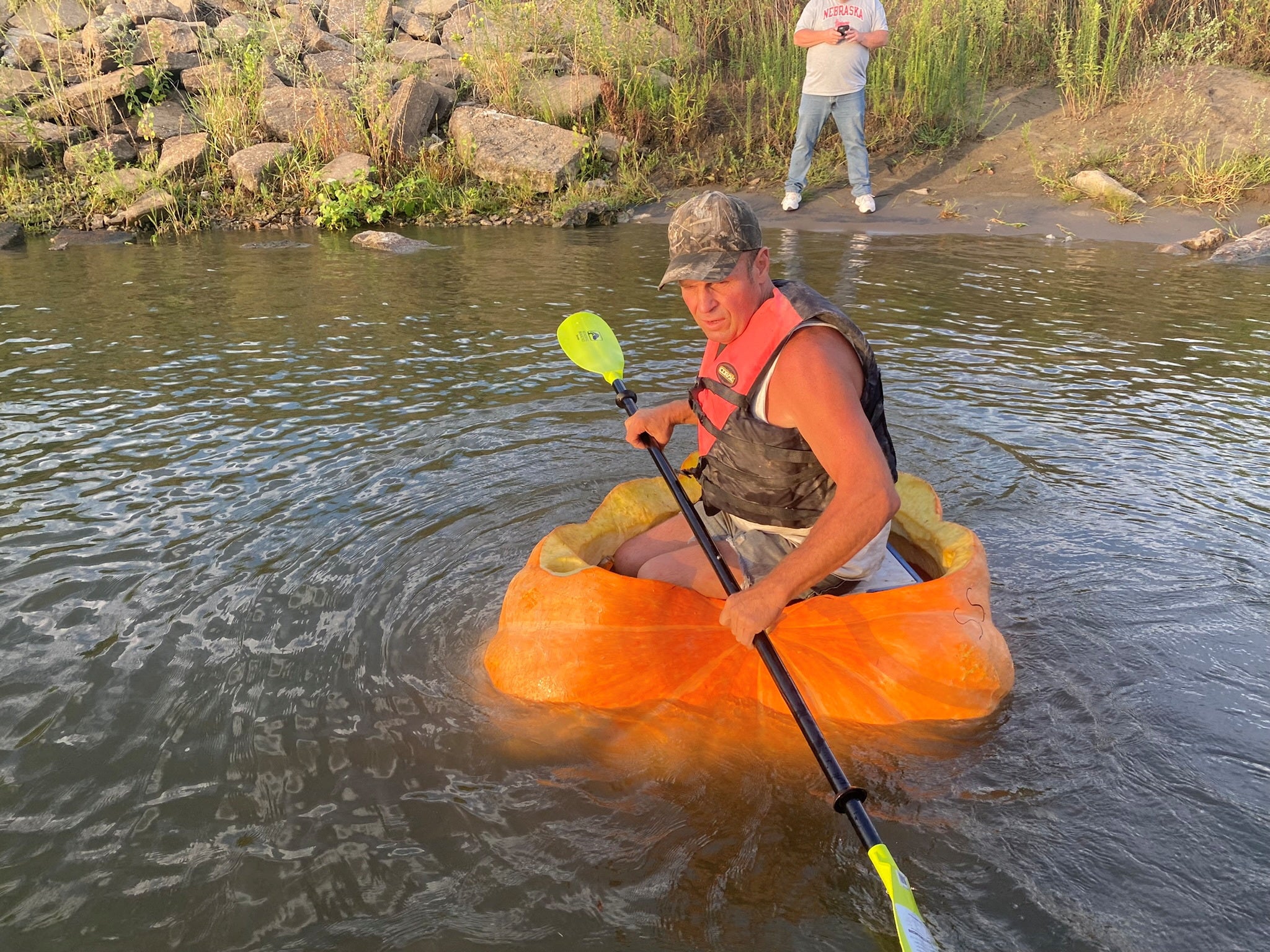 A man floats down the Missouri River in a giant hollowed out pumpkin, in Bellevue, Nebraska