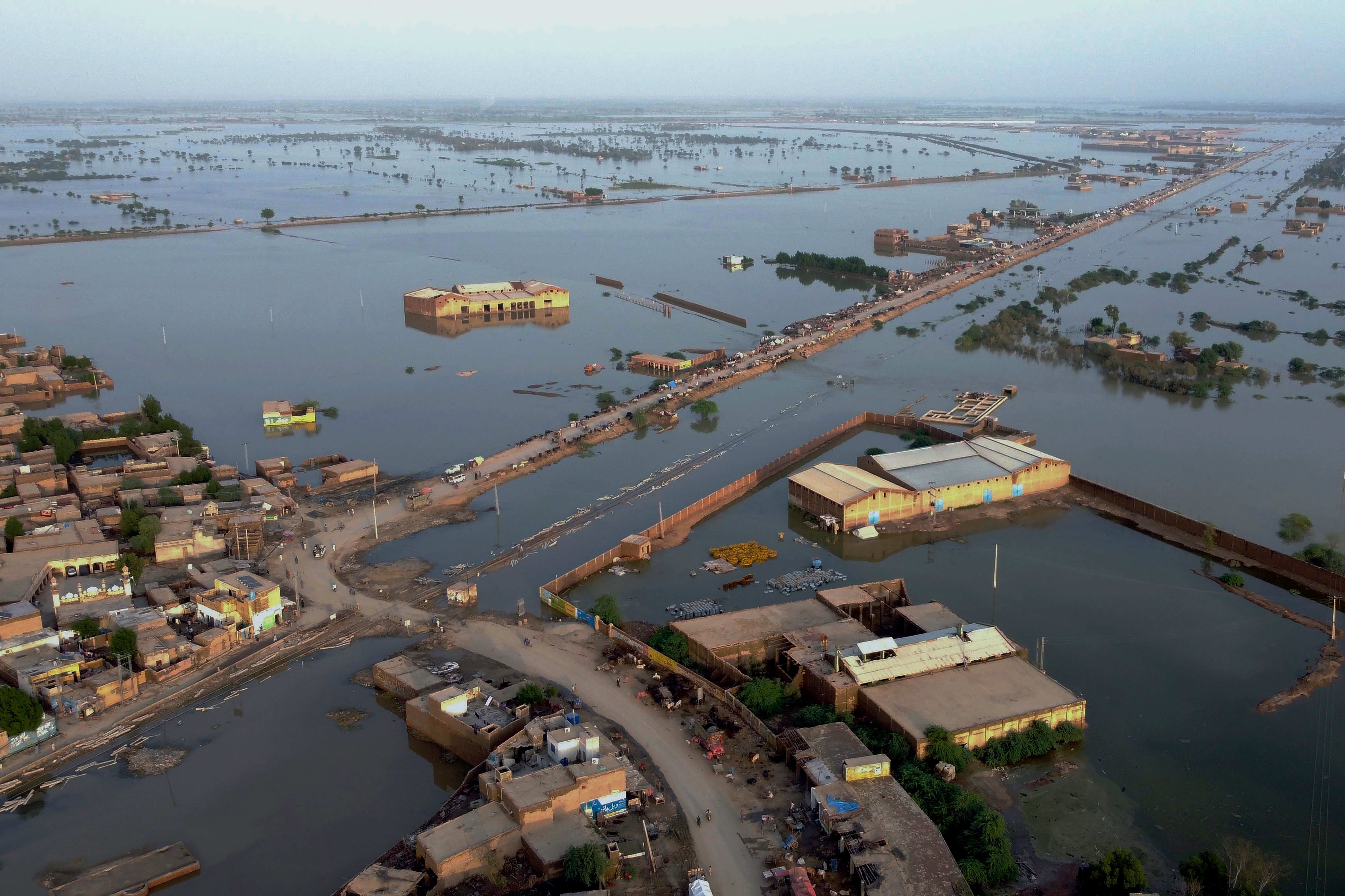 Homes surrounded by floodwaters in Sohbat Pur city, Pakistan (Zahid Hussain/AP)