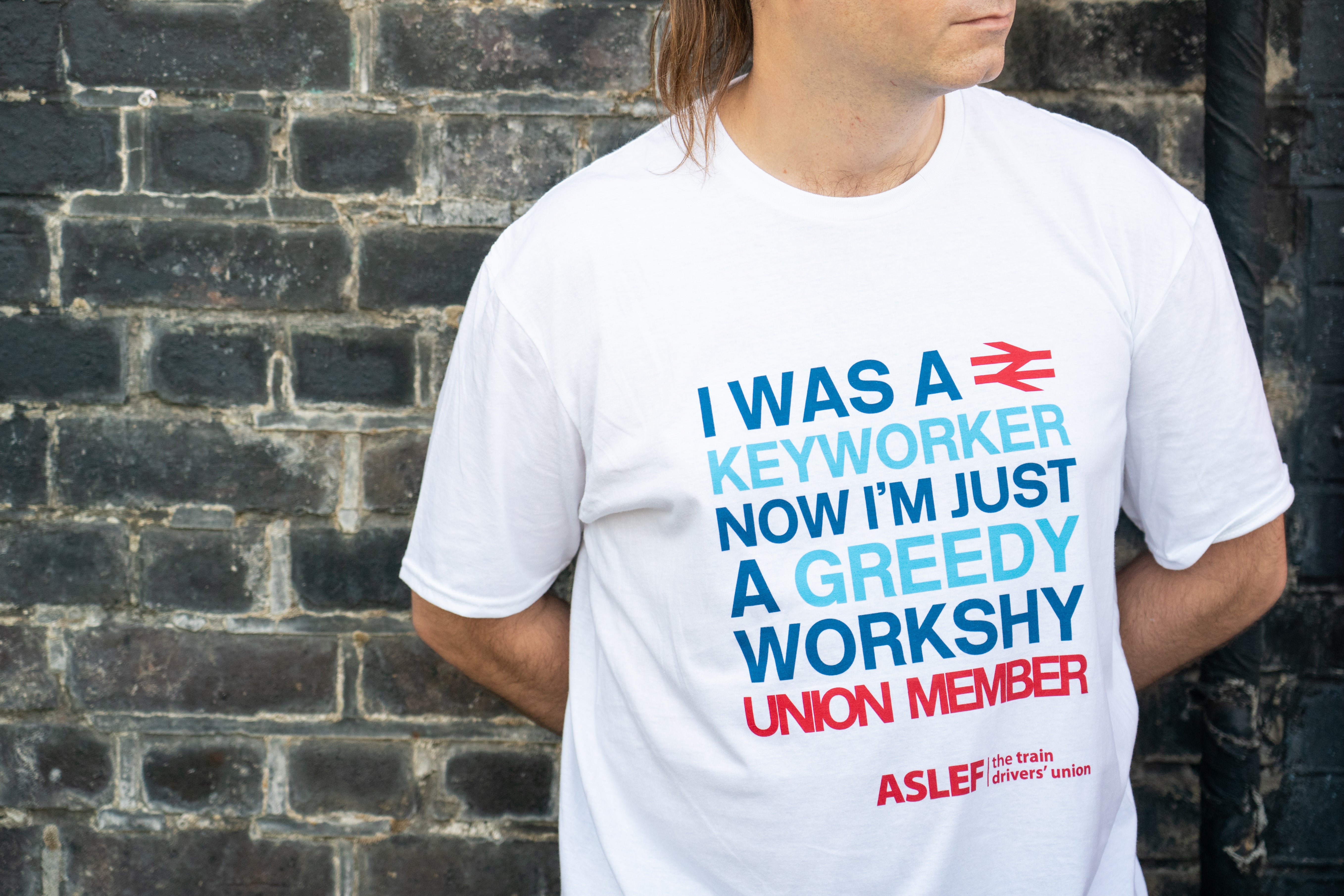 An Aslef member at a picket line at Willesden Junction station (PA)