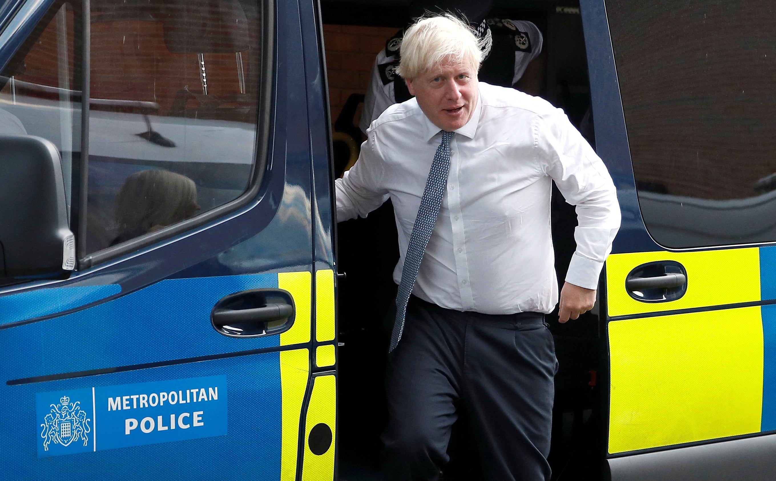 Prime Minister Boris Johnson leaves a police vehicle after watching a drugs-related raid by Metropolitan Police officers (Peter Nicholls/PA)