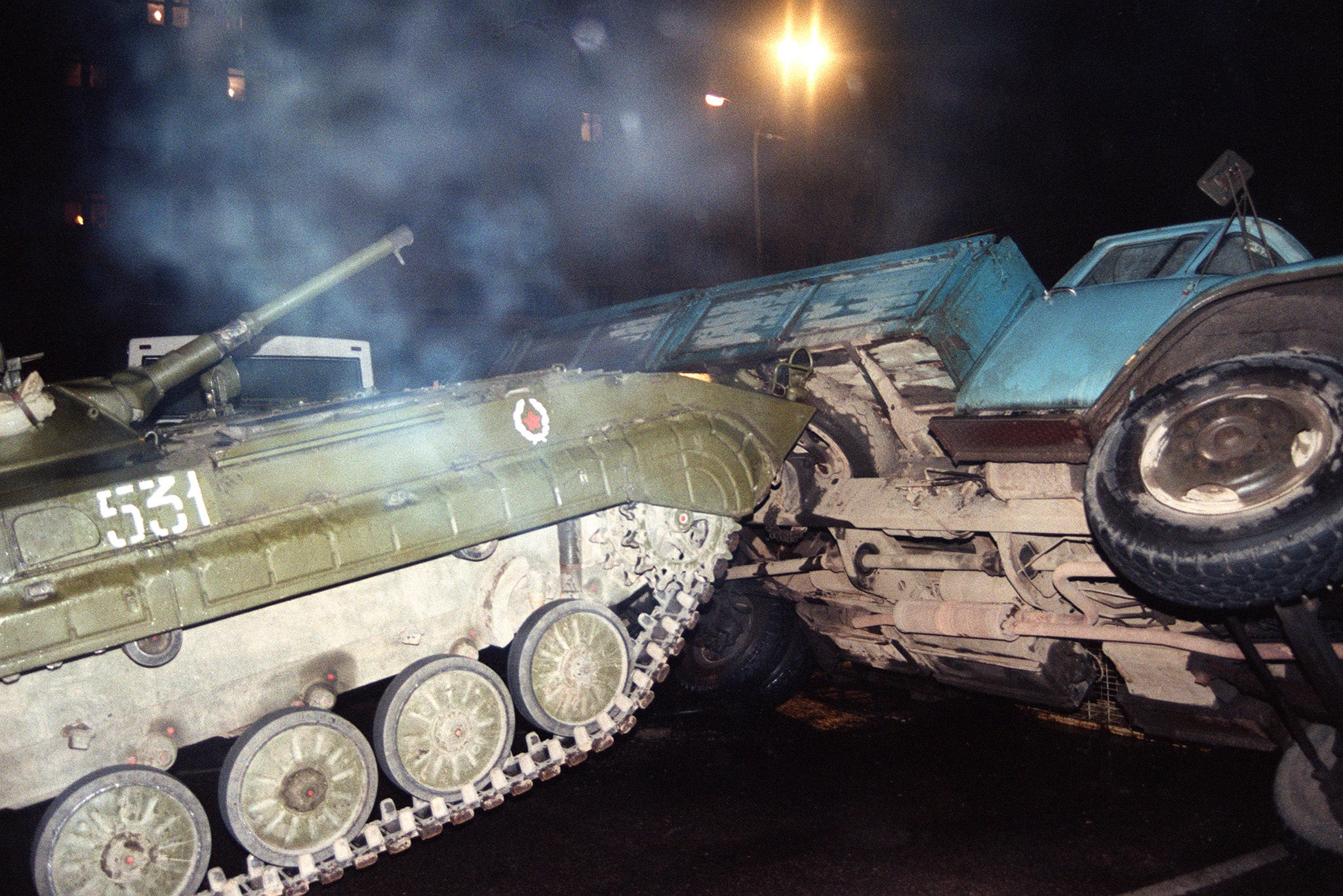 20 August 1991: a Soviet army tank pushes over a truck barring the road in the centre of Moscow