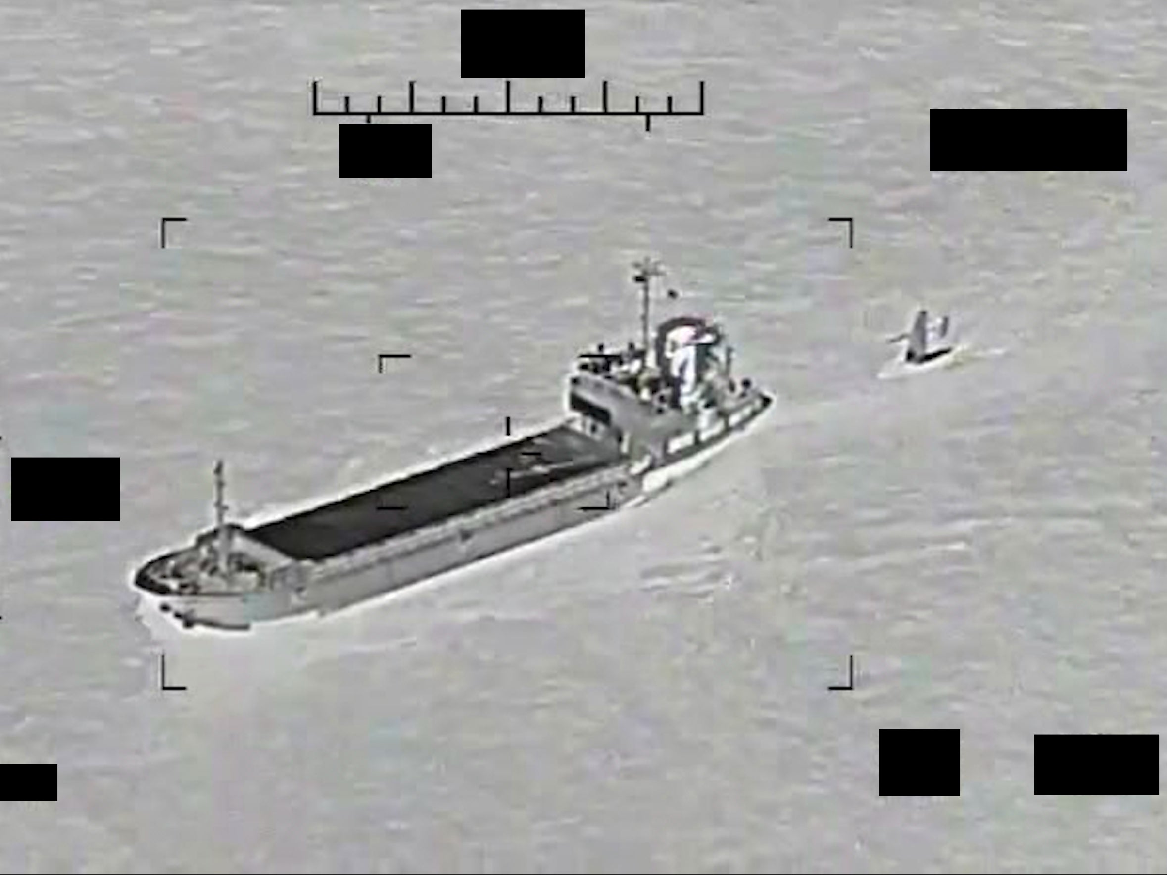 This photo released by the U.S. Navy shows the Iranian Revolutionary Guard ship Shahid Bazair, left, towing a U.S. Navy Saildrone Explorer in the Persian Gulf on Tuesday, Aug. 30, 2022