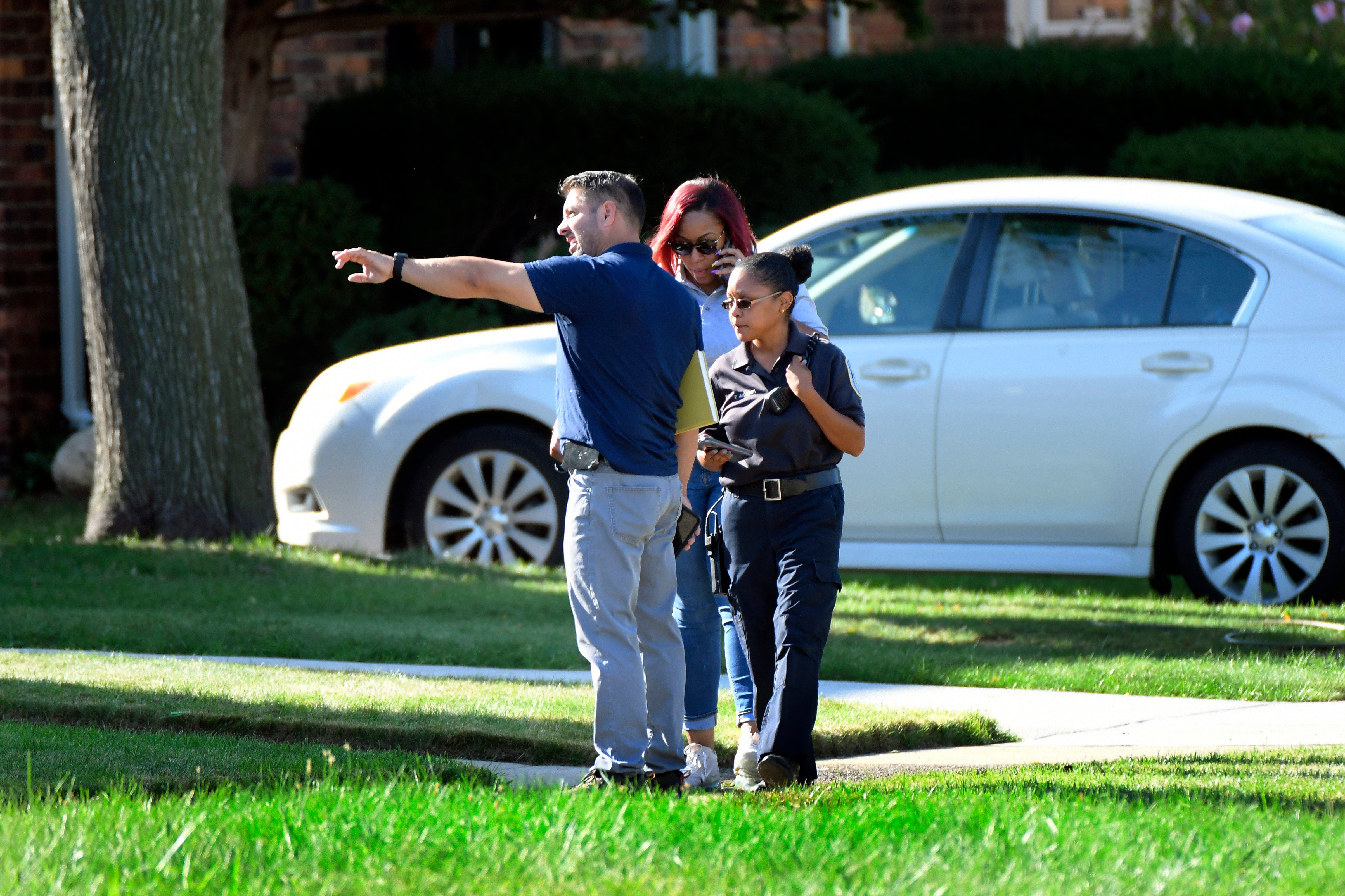 Detroit Police and investigators look over a shooting scene on Pennington Drive, north of Seven Mile Road, Sunday, Aug. 28, 2022, in Detroit