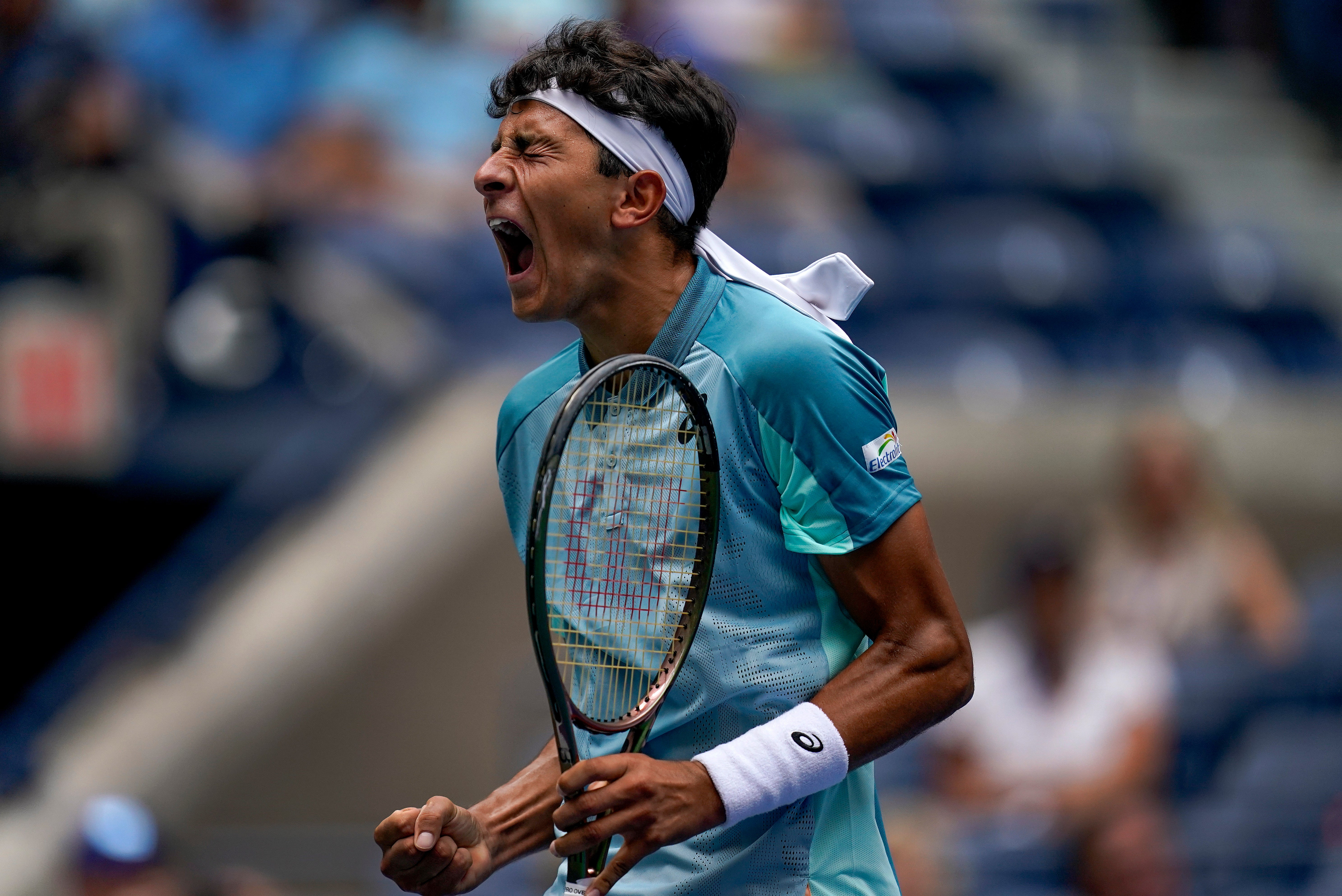 Emilio Nava celebrates winning the first set (Julia Nikhinson/AP)