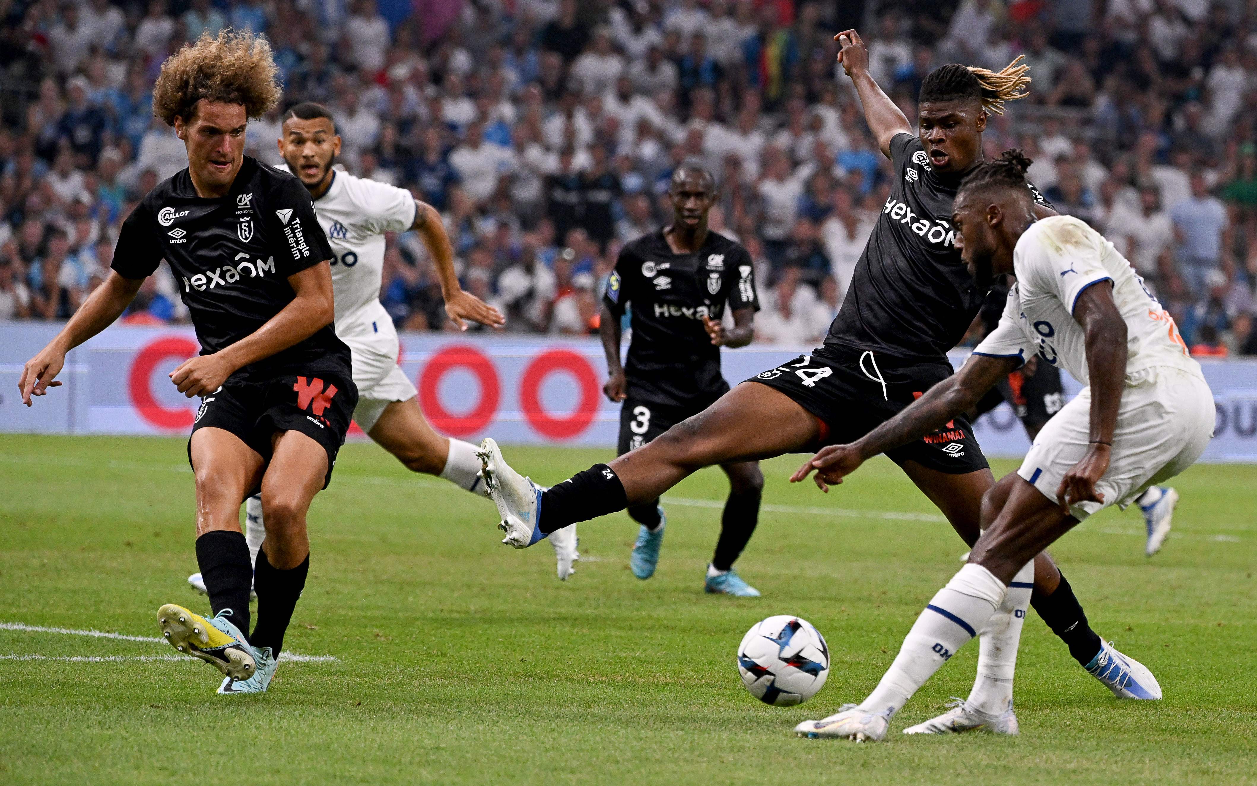 Wout Faes, left, in action for Reims