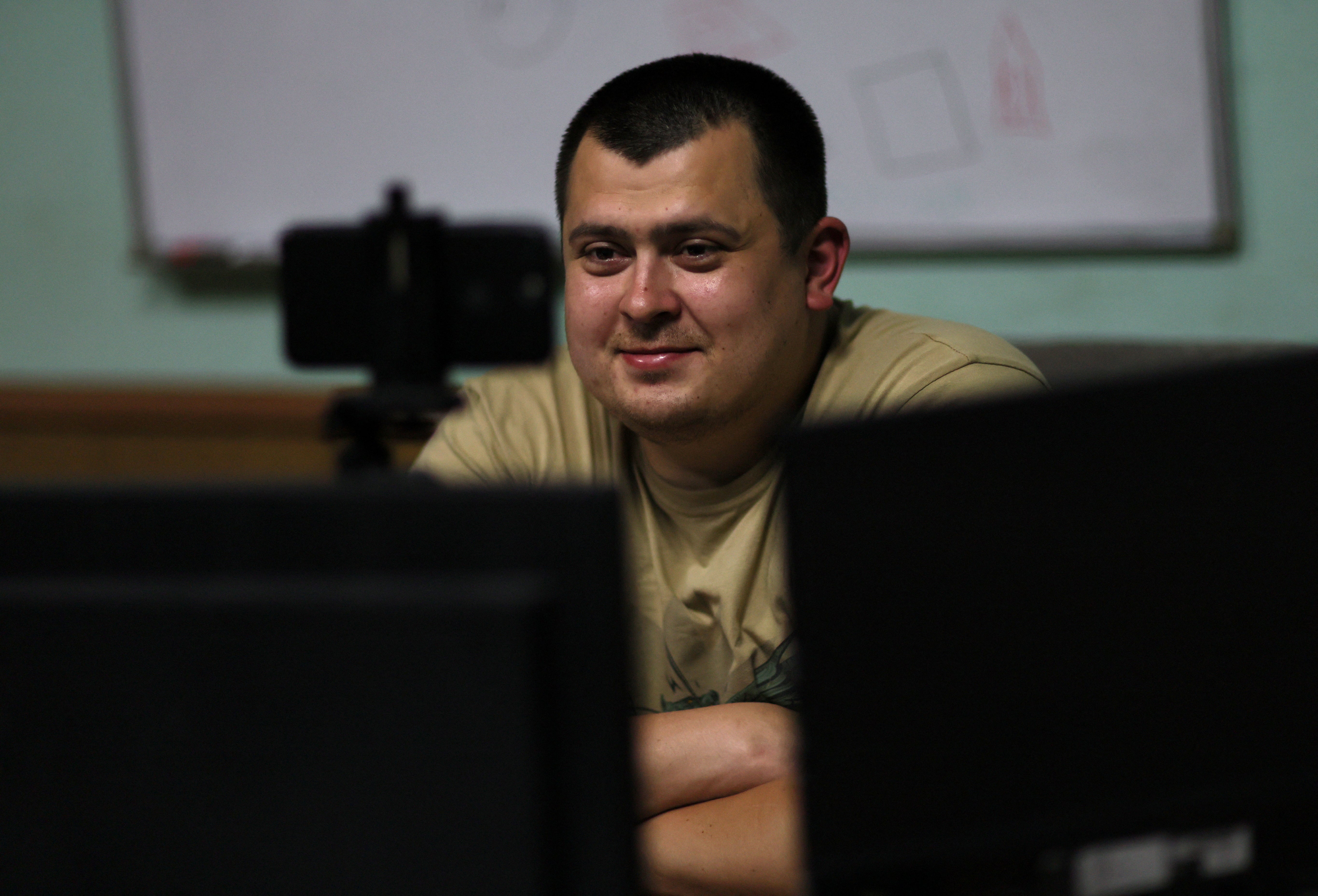 Fire chief Roman Kachanov video chats with his wife and child who are taking refuge in Germany